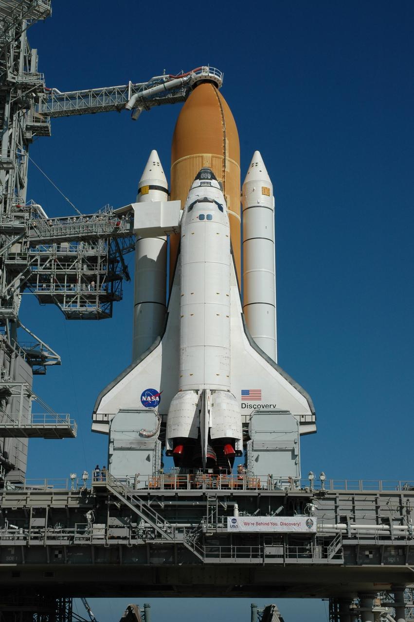 KENNEDY SPACE CENTER, FLA. -- Space Shuttle Discovery and the mobile launcher platform sit on Launch Pad 39B. The shuttle's external tank is capped by the oxygen vent hood (at top). Below it is the orbiter access arm which swings out from the fixed service structure to the orbiter crew compartment hatch to allow personnel to enter the crew compartment. The outer end of the access arm ends in an environmental chamber (white room) that mates with the orbiter and holds six persons. The arm remains in the extended position until seven minutes 24 seconds before launch to provide emergency egress for the flight crew. The rollout of Discovery from the Vehicle Assembly Building began at 12:29 a.m. The shuttle was harddown on the pad at 9:03 a.m. The mission is No. 20 to the International Space Station and construction flight 12A.1. The mission payload is the SPACEHAB module, the P5 integrated truss structure and other key components. The launch window for mission STS-116 opens Dec. 7. Photo credit: NASA/Jim Grossmann