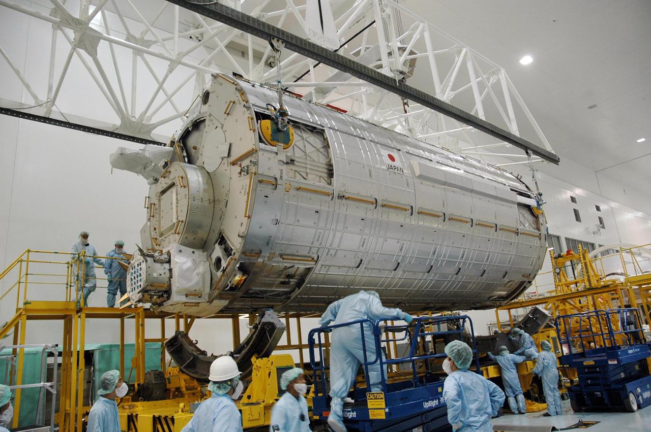 KENNEDY SPACE CENTER, FLA. --  In the Space Station Processing Facility, an overhead crane lifts the Japanese Experiment Module (JEM) off of its transporter.  The module is being moved to another stand where it will be weighed and measured for its center of gravity. The Japanese Aerospace Exploration Agency developed the laboratory at the Tsukuba Space Center near Tokyo. It is the first element, named "Kibo" (Hope), to be delivered to KSC. The JEM is Japan's primary contribution to the International Space Station. It will enhance the unique research capabilities of the orbiting complex by providing an additional environment for astronauts to conduct science experiments. The JEM is targeted for mission STS-124, to launch in early 2008.  Photo credit: NASA/Troy Cryder