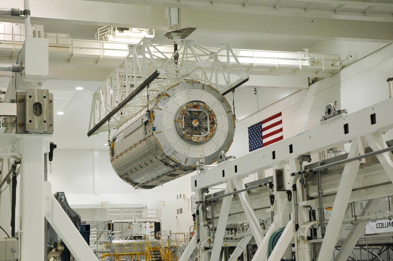 KENNEDY SPACE CENTER, FLA. --  In the Space Station Processing Facility, an overhead crane carries the Japanese Experiment Module (JEM) across the facility.  The module is being moved to another stand where it will be weighed and measured for its center of gravity. The Japanese Aerospace Exploration Agency developed the laboratory at the Tsukuba Space Center near Tokyo. It is the first element, named "Kibo" (Hope), to be delivered to KSC. The JEM is Japan's primary contribution to the International Space Station. It will enhance the unique research capabilities of the orbiting complex by providing an additional environment for astronauts to conduct science experiments. The JEM is targeted for mission STS-124, to launch in early 2008.  Photo credit: NASA/Troy Cryder