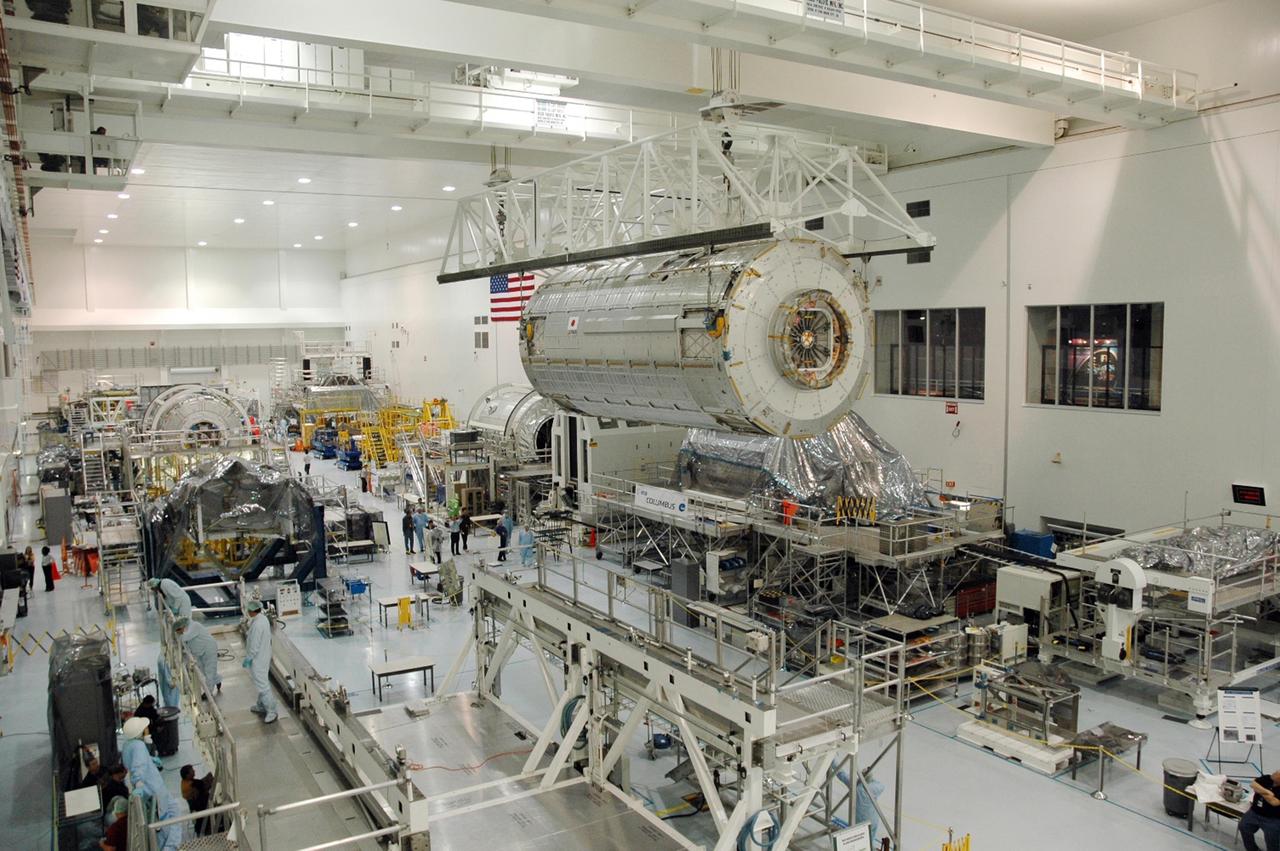 KENNEDY SPACE CENTER, FLA. --  In the Space Station Processing Facility, an overhead crane carries the Japanese Experiment Module (JEM) across the facility.  The module is being moved to another stand where it will be weighed and measured for its center of gravity.  Other modules intended for the International Space Station are visible on other stands.  The Japanese Aerospace Exploration Agency developed the laboratory at the Tsukuba Space Center near Tokyo. It is the first element, named "Kibo" (Hope), to be delivered to KSC. The JEM is Japan's primary contribution to the International Space Station. It will enhance the unique research capabilities of the orbiting complex by providing an additional environment for astronauts to conduct science experiments. The JEM is targeted for mission STS-124, to launch in early 2008.  Photo credit: NASA/Troy Cryder
