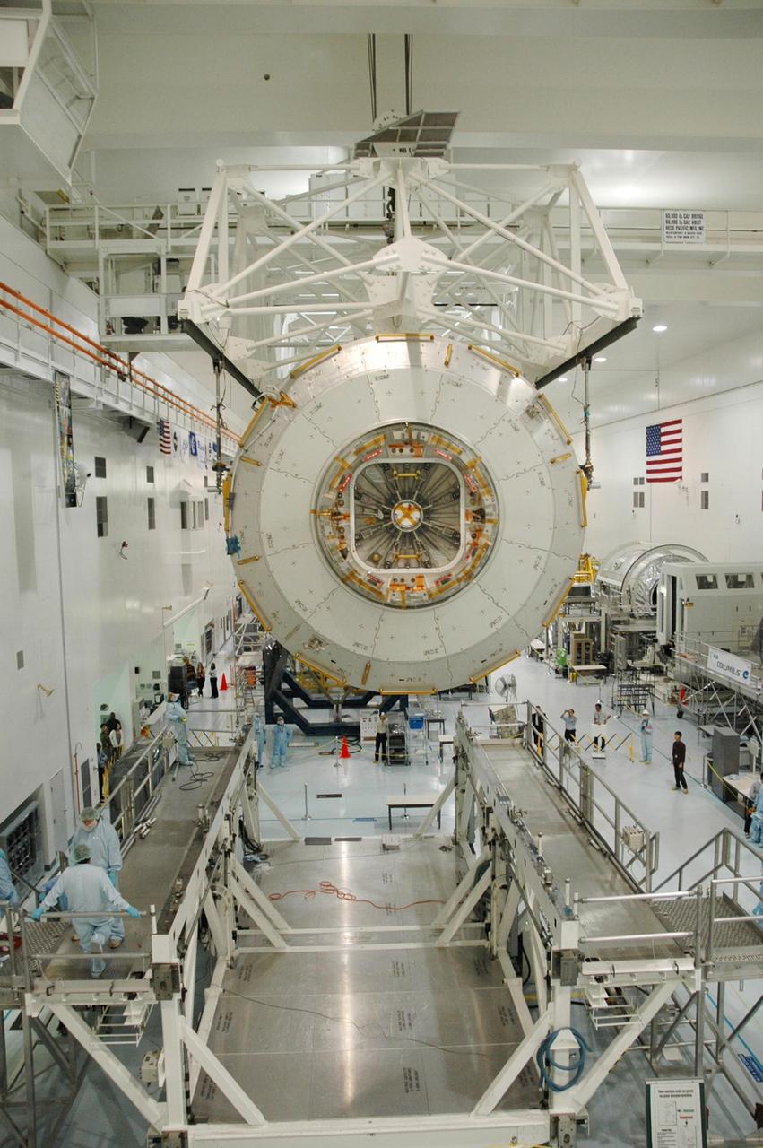 KENNEDY SPACE CENTER, FLA. --  In the Space Station Processing Facility, an overhead crane begins lowering the Japanese Experiment Module (JEM) onto a weighing stand.  The module will also be measured for its center of gravity.  The Japanese Aerospace Exploration Agency developed the laboratory at the Tsukuba Space Center near Tokyo. It is the first element, named "Kibo" (Hope), to be delivered to KSC. The JEM is Japan's primary contribution to the International Space Station. It will enhance the unique research capabilities of the orbiting complex by providing an additional environment for astronauts to conduct science experiments. The JEM is targeted for mission STS-124, to launch in early 2008.  Photo credit: NASA/Troy Cryder