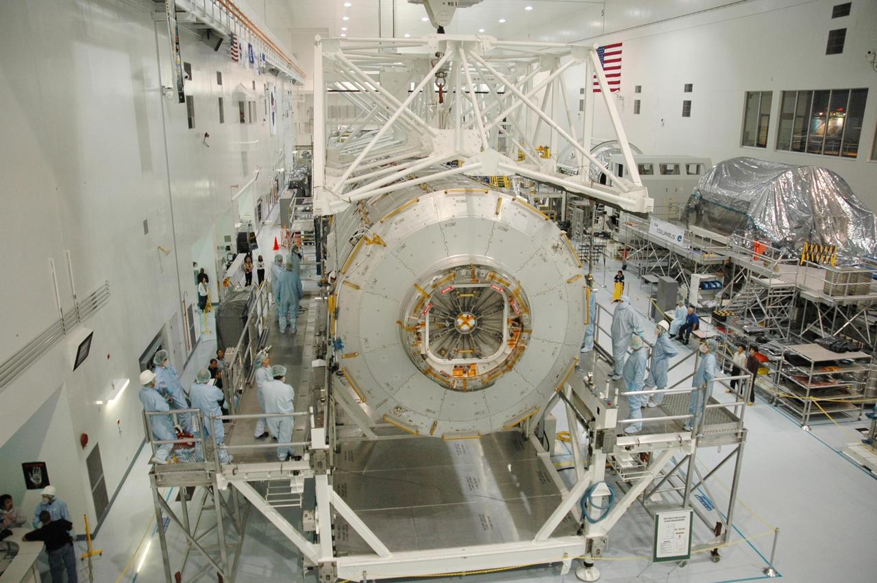 KENNEDY SPACE CENTER, FLA. --   In the Space Station Processing Facility, workers observe as an overhead crane lowers the Japanese Experiment Module (JEM) onto a weighing stand.  The module will also be measured for its center of gravity. The Japanese Aerospace Exploration Agency developed the laboratory at the Tsukuba Space Center near Tokyo. It is the first element, named "Kibo" (Hope), to be delivered to KSC. The JEM is Japan's primary contribution to the International Space Station. It will enhance the unique research capabilities of the orbiting complex by providing an additional environment for astronauts to conduct science experiments. The JEM is targeted for mission STS-124, to launch in early 2008.  Photo credit: NASA/Troy Cryder