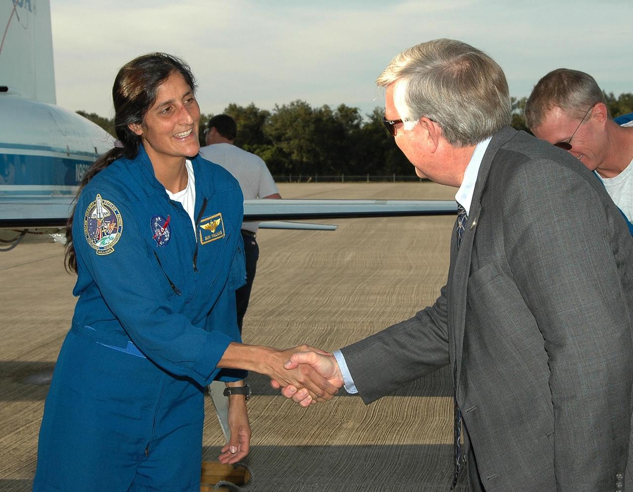 KENNEDY SPACE CENTER, FLA. -- Expedition 14 Flight Engineer Sunita Williams is greeted by Kennedy Space Center Director Jim Kennedy at the Shuttle Landing Facility. Williams will be traveling to the International Space Station with the STS-116 crew. The crew has returned to KSC for the terminal countdown demonstration test, which are pre-launch preparations that include a simulated launch countdown. Crew members also include Commander Mark Polansky, Pilot William Oefelein, Mission Specialists Nicholas Patrick, Robert Curbeam, Christer Fuglesang and Joan Higginbotham. The mission is No. 20 to the International Space Station and construction flight 12A.1. The mission payload is the SPACEHAB module, the P5 integrated truss structure and other key components. Launch is scheduled for no earlier than Dec. 7. Photo credit: NASA/Kim Shiflett