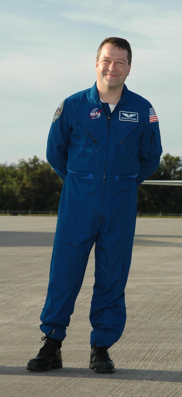 KENNEDY SPACE CENTER, FLA. -- After arrival at the Shuttle Landing Facility, STS-116 Mission Specialist Nicholas Patrick poses for the media. The crew has returned to KSC for the terminal countdown demonstration test, which are prelaunch preparations that include a simulated launch countdown.  Other crew members are Commander Mark Polansky, Pilot William Oefelein and Mission Specialists Sunita Williams, Joan Higginbotham, Christer Fuglesang and Robert Curbeam. Fuglesang, who is from Sweden, represents the European Space Agency.  The mission is No. 20 to the International Space Station and construction flight 12A.1.  The mission payload is the SPACEHAB module, the P5 integrated truss structure and other key components. Launch is scheduled for no earlier than Dec. 7. Photo credit: NASA/Kim Shiflett