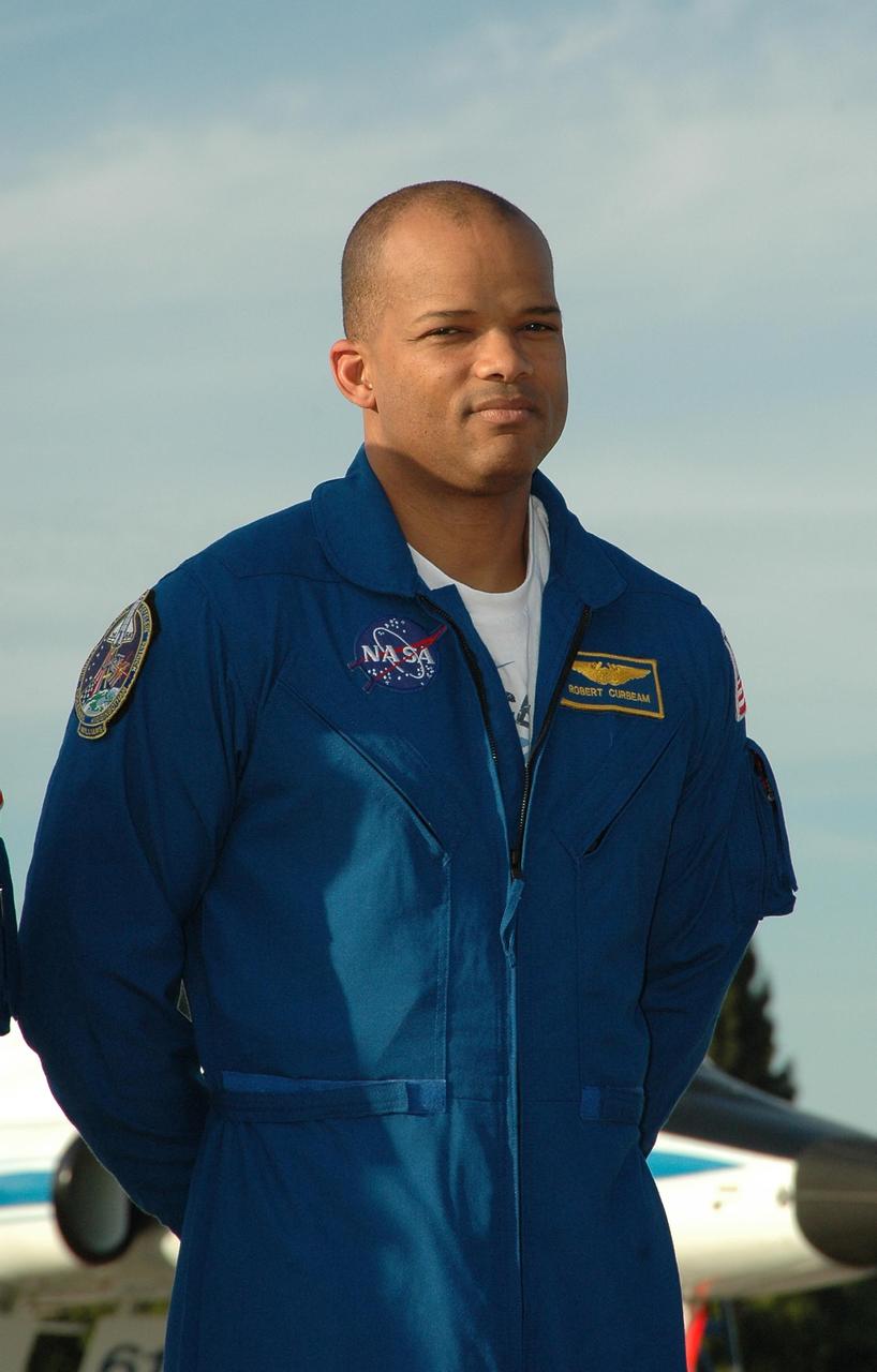 KENNEDY SPACE CENTER, FLA. -- After arrival at the Shuttle Landing Facility, STS-116 Mission Specialist Robert Curbeam poses for the media. The crew has returned to KSC for the terminal countdown demonstration test, which are prelaunch preparations that include a simulated launch countdown.  Other crew members are Commander Mark Polansky, Pilot William Oefelein and Mission Specialists Joan Higginbotham, Sunita Williams, Nicholas Patrick and Christer Fuglesang, who represents the European Space Agency.  The mission is No. 20 to the International Space Station and construction flight 12A.1.  The mission payload is the SPACEHAB module, the P5 integrated truss structure and other key components. Launch is scheduled for no earlier than Dec. 7. Photo credit: NASA/Kim Shiflett