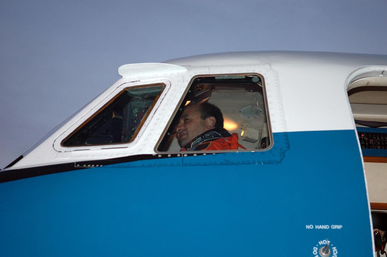 KENNEDY SPACE CENTER, FLA. -- At the Shuttle Landing Facility, STS-116 Commander Mark Polansky is in the pilot's seat of the shuttle training aircraft (STA), getting ready to practice landing the orbiter. The mission crew is at KSC for the terminal countdown demonstration test, which are prelaunch preparations that include a simulated launch countdown. STA practice is part of the TCDT. The STA is a Grumman American Aviation-built Gulf Stream II jet that was modified to simulate an orbiter's cockpit, motion and visual cues, and handling qualities. In flight, the STA duplicates the orbiter's atmospheric descent trajectory from approximately 35,000 feet altitude to landing on a runway. Because the orbiter is unpowered during re-entry and landing, its high-speed glide must be perfectly executed the first time. Photo credit: NASA/Kim Shiflett