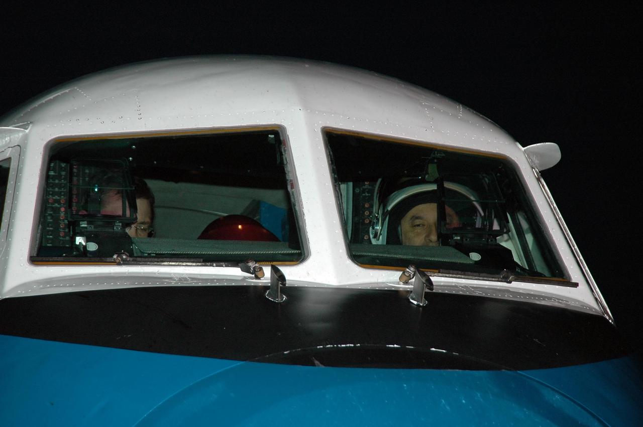 KENNEDY SPACE CENTER, FLA. -- Inside the shuttle training aircraft at the Shuttle Landing Facility, STS-116 Pilot William Oefelein (left) and Commander Mark Polansky are seated in the cockpit, getting ready to practice landing the orbiter.  The mission crew is at KSC for the terminal countdown demonstration test, which are prelaunch preparations that include a simulated launch countdown.  STA practice is part of the TCDT. The STA is a Grumman American Aviation-built Gulf Stream II jet that was modified to simulate an orbiter's cockpit, motion and visual cues, and handling qualities. In flight, the STA duplicates the orbiter's atmospheric descent trajectory from approximately 35,000 feet altitude to landing on a runway. Because the orbiter is unpowered during re-entry and landing, its high-speed glide must be perfectly executed the first time. Photo credit: NASA/Kim Shiflett