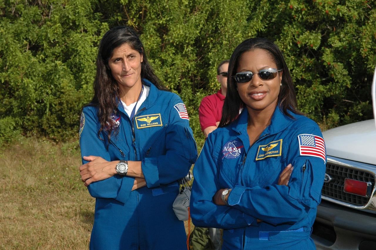 KENNEDY SPACE CENTER, FLA. -- STS-116 Mission Specialists Sunita Williams (left) and Joan Higginbotham listen to instructions on use of the M-113 armored personnel carrier that could be used to move them quickly away from the launch pad in the event of an emergency. The mission crew is at KSC for terminal countdown demonstration test (TCDT) activities that are preparation for launch. Other crew members are Commander Mark Polansky, Pilot William Oefelein and Mission Specialists Robert Curbeam, Nicholas Patrick and Christer Fuglesang, who represents the European Space Agency. The STS-116 mission is No. 20 to the International Space Station and construction flight 12A.1. The mission payload is the SPACEHAB module, the P5 integrated truss structure and other key components. Launch is scheduled for no earlier than Dec. 7. Photo credit: NASA/Kim Shiflett
