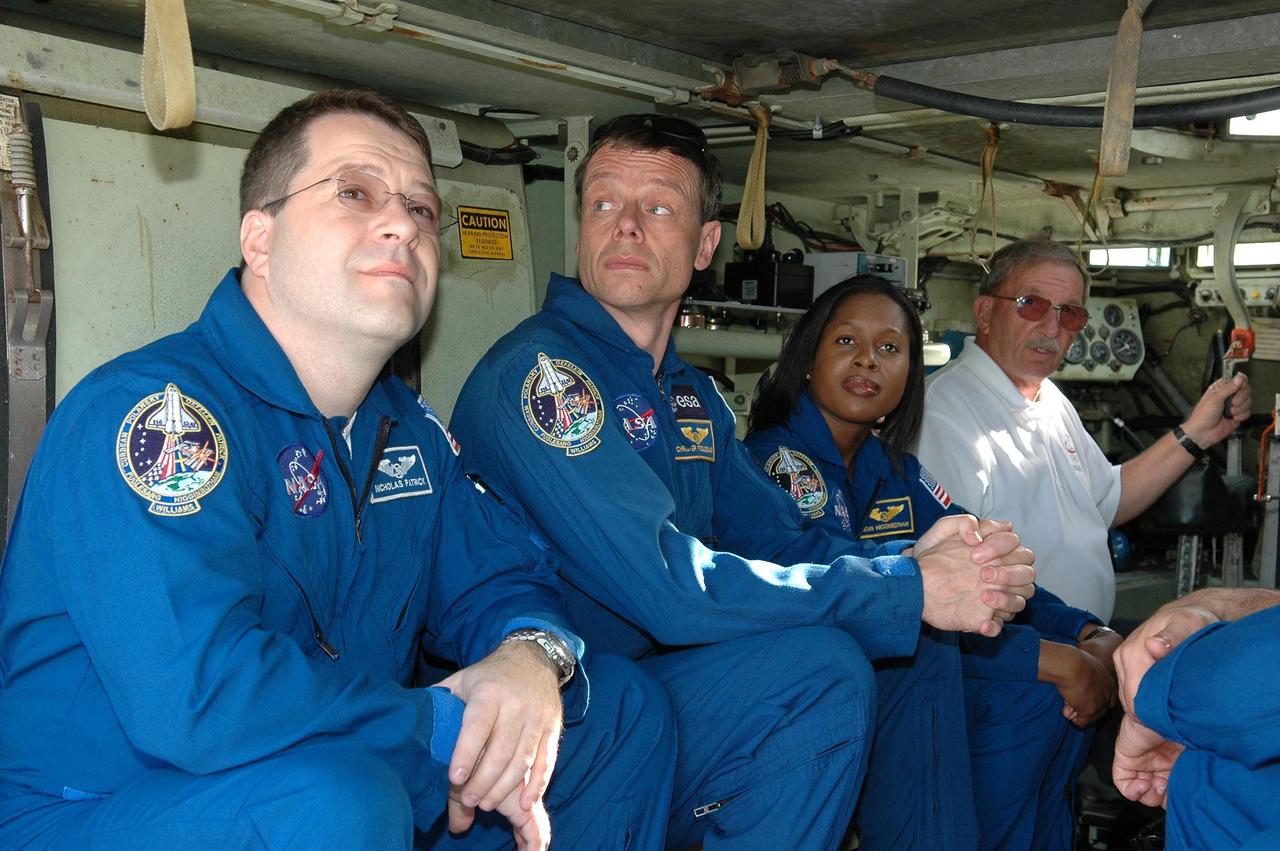 KENNEDY SPACE CENTER, FLA. --  STS-116 crew members wait for a practice ride in the M-113 armored personnel carrier.  The mission crew is at KSC for terminal countdown demonstration test (TCDT) activities that are preparation for launch. On the left are Mission Specialists Nicholas Patrick, Christer Fuglesang and Joan Higginbotham, and Capt. George Hoggard, who is astronaut rescue team leader. Not pictured are Commander Mark Polansky, Pilot William Oefelein and Mission Specialists Sunita Williams and Robert Curbeam. The M-113 could be used to move the crew quickly away from the launch pad in the event of an emergency. The STS-116 mission is No. 20 to the International Space Station and construction flight 12A.1.  The mission payload is the SPACEHAB module, the P5 integrated truss structure and other key components. Launch is scheduled for no earlier than Dec. 7.  Photo credit: NASA/Kim Shiflett