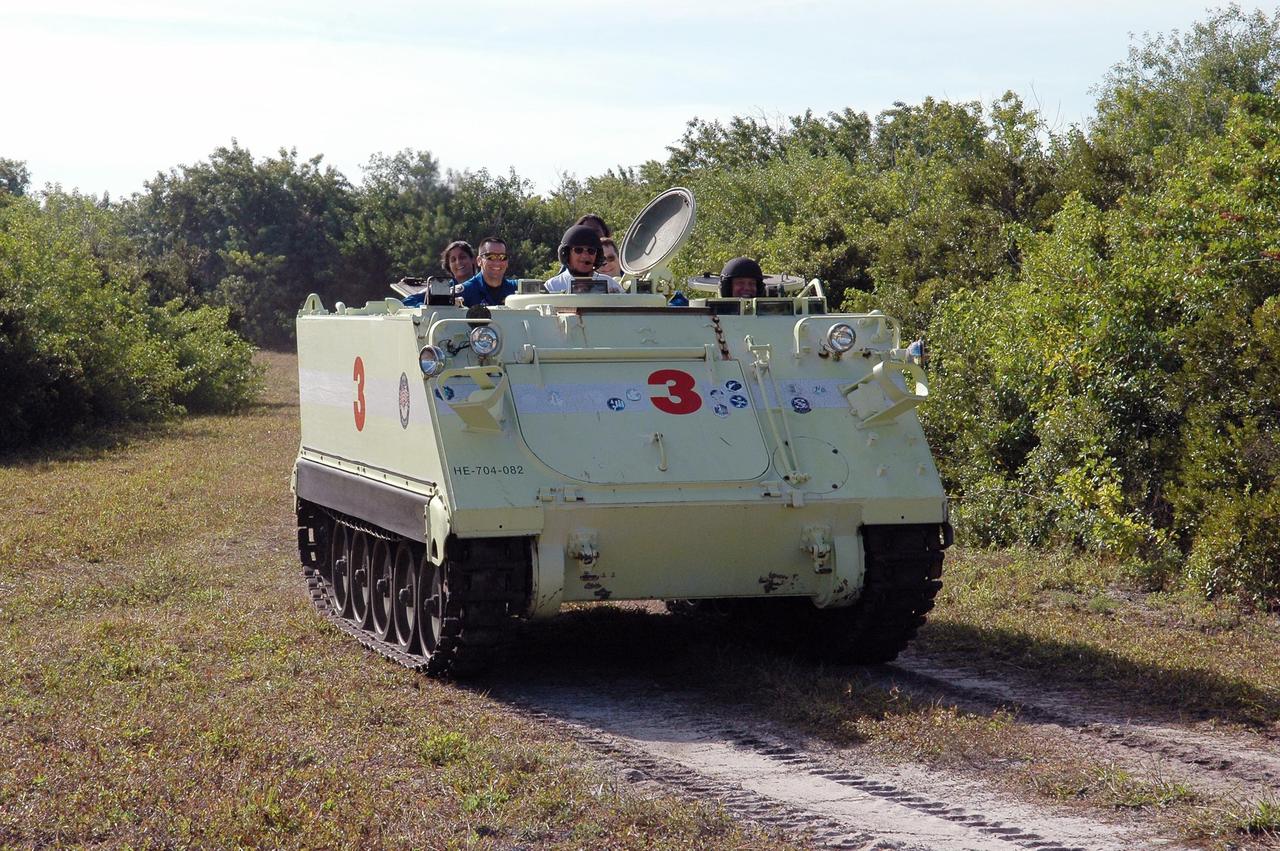 KENNEDY SPACE CENTER, FLA. --   STS-116 Mission Specialist Christer Fuglesang practices driving the M-113 armored personnel carrier.  Fuglesang represents the European Space Agency. The mission crew is at KSC for terminal countdown demonstration test (TCDT) activities that are preparation for launch. The M-113 could be used to move the crew quickly away from the launch pad in the event of an emergency.  At left of Fuglesang is Capt. George Hoggard, who is astronaut rescue team leader.  Other crew members on the M-113, behind Hoggard, are Mission Specialist Sunita Williams, Pilot William Oefelein and Nicholas Patrick. In the background is Mission Specialist Joan Higginbotham. The STS-116 mission is No. 20 to the International Space Station and construction flight 12A.1.  The mission payload is the SPACEHAB module, the P5 integrated truss structure and other key components. Launch is scheduled for no earlier than Dec. 7.  Photo credit: NASA/Kim Shiflett
