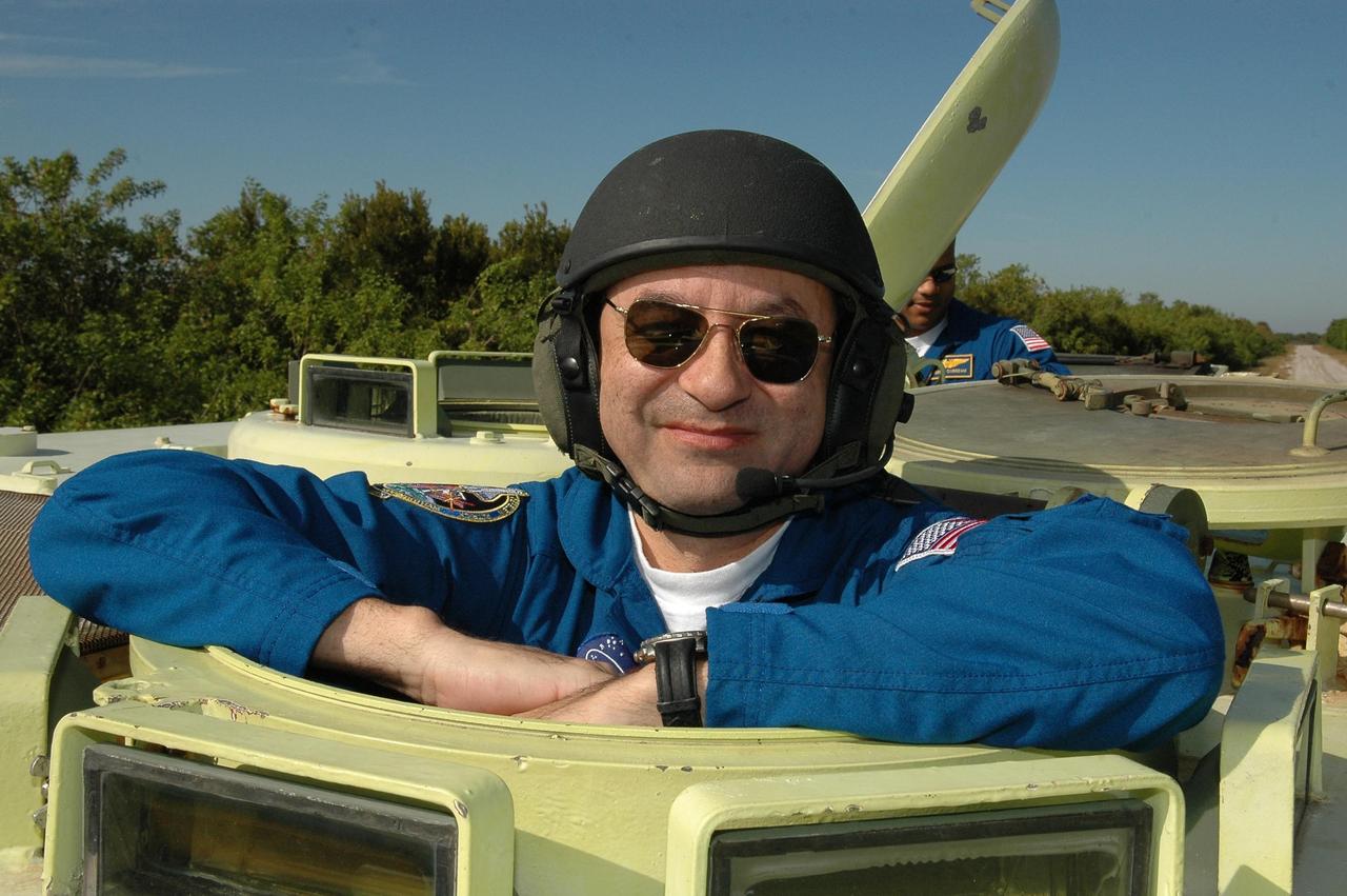 KENNEDY SPACE CENTER, FLA. --  STS-116 Commander Mark Polansky is ready for his turn at driving the M-113 armored personnel carrier.  The mission crew is at KSC for terminal countdown demonstration test (TCDT) activities that are preparation for launch. The M-113 could be used to move the crew quickly away from the launch pad in the event of an emergency.  Behind Polansky is Mission Specialist Robert Curbeam. The STS-116 mission is No. 20 to the International Space Station and construction flight 12A.1.  The mission payload is the SPACEHAB module, the P5 integrated truss structure and other key components. Launch is scheduled for no earlier than Dec. 7.  Photo credit: NASA/Kim Shiflett