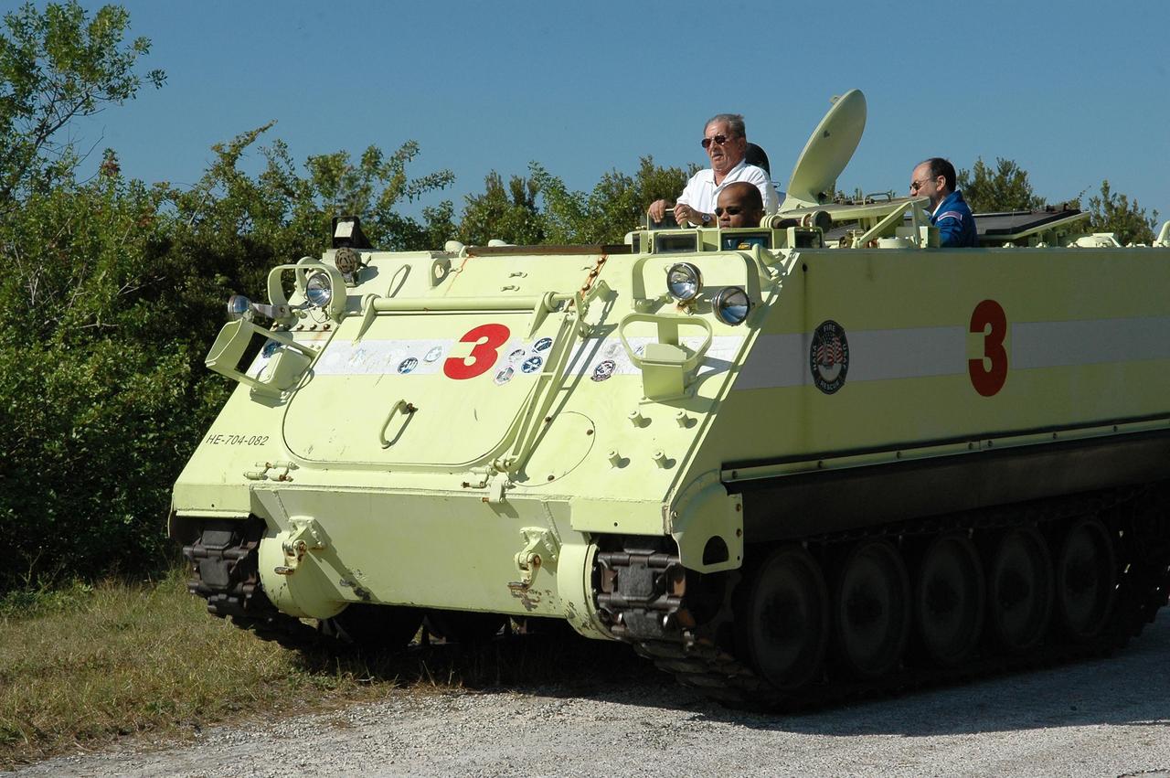 KENNEDY SPACE CENTER, FLA. --  STS-116 Mission Specialist Robert Curbeam practices driving the M-113 armored personnel carrier.  The mission crew is at KSC for terminal countdown demonstration test (TCDT) activities that are preparation for launch. The M-113 could be used to move the crew quickly away from the launch pad in the event of an emergency.  At left of Polansky is Capt. George Hoggard, who is astronaut rescue team leader.  In the back of the M-113, at right, is Commander Mark Polansky.  The STS-116 mission is No. 20 to the International Space Station and construction flight 12A.1.  The mission payload is the SPACEHAB module, the P5 integrated truss structure and other key components. Launch is scheduled for no earlier than Dec. 7.  Photo credit: NASA/Kim Shiflett