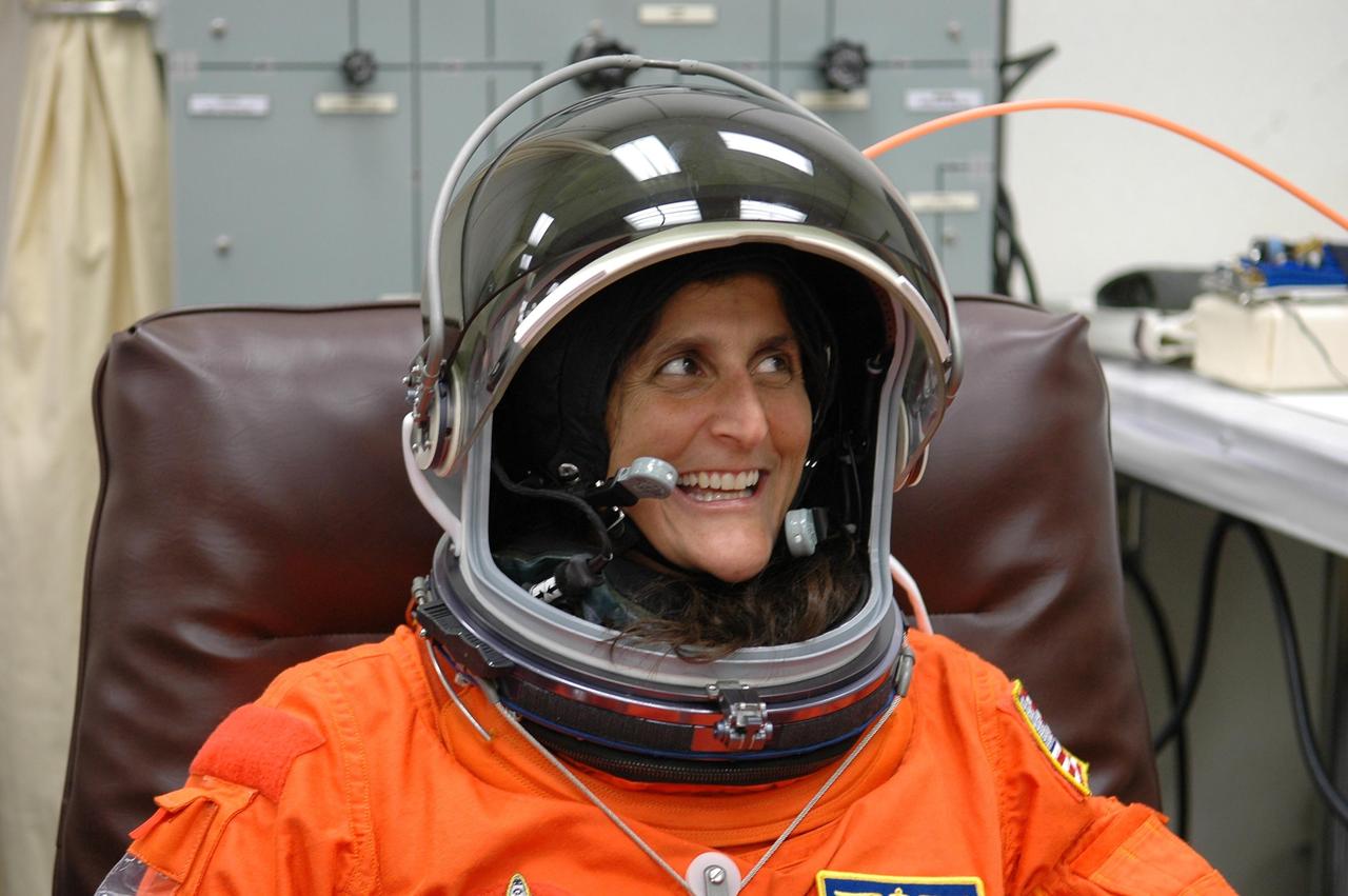 KENNEDY SPACE CENTER, FLA. -- STS-116 Mission Specialist Sunita Williams is enthusiastic about donning her launch suit to check the fit, including the helmet, which is part of the prelaunch preparations during terminal countdown demonstration test (TCDT) activities. The mission crew is at KSC for the TCDT, which includes a simulated launch countdown. The STS-116 mission is No. 20 to the International Space Station and construction flight 12A.1. The mission payload is the SPACEHAB module, the P5 integrated truss structure and other key components. Launch is scheduled for no earlier than Dec. 7. Photo credit: NASA/Kim Shiflett