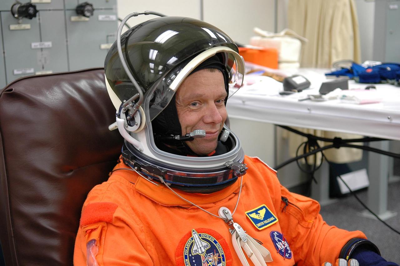 KENNEDY SPACE CENTER, FLA. -- STS-116 Mission Specialist Christer Fuglesang checks the fit of his helmet during suit fit-check, part of the prelaunch preparations during terminal countdown demonstration test (TCDT) activities. The mission crew is at KSC for the TCDT, which includes a simulated launch countdown. Fuglesang represents the European Space Agency. The STS-116 mission is No. 20 to the International Space Station and construction flight 12A.1. The mission payload is the SPACEHAB module, the P5 integrated truss structure and other key components. Launch is scheduled for no earlier than Dec. 7. Photo credit: NASA/Kim Shiflett