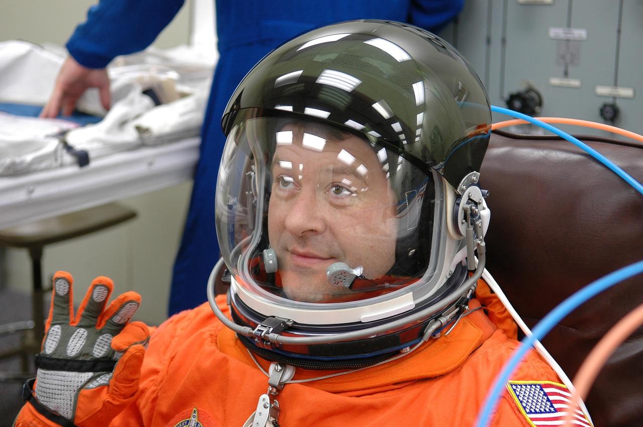 KENNEDY SPACE CENTER, FLA. -- STS-116 Mission Specialist Nicholas Patrick checks the fit of his gloves during suit fit-check, part of the prelaunch preparations during terminal countdown demonstration test (TCDT) activities.  The mission crew is at KSC for the TCDT, which includes a simulated launch countdown.  The STS-116 mission is No. 20 to the International Space Station and construction flight 12A.1.  The mission payload is the SPACEHAB module, the P5 integrated truss structure and other key components. Launch is scheduled for no earlier than Dec. 7.  Photo credit: NASA/Kim Shiflett