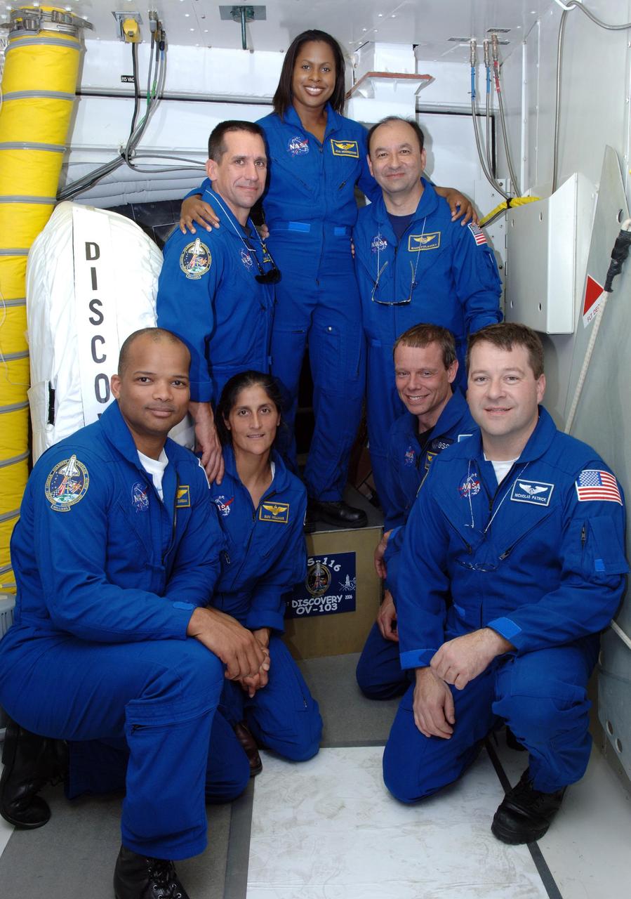 KENNEDY SPACE CENTER, FLA. --  The mission STS-116 crew poses in the White Room on Launch Pad 39B.  Clockwise from left are Mission Specialists Robert Curbeam and Sunita Williams, Pilot William Oefelein, Mission Specialist Joan Higginbotham, Commander Mark Polansky, and Mission Specialists Christer Fuglesang and Nicholas Patrick.  Fuglesang represents the European Space Agency. The mission crew is at KSC for the TCDT, which includes a simulated launch countdown.   The STS-116 mission is No. 20 to the International Space Station and construction flight 12A.1.  The mission payload is the SPACEHAB module, the P5 integrated truss structure and other key components. Launch is scheduled for no earlier than Dec. 7.  Photo credit: NASA/Kim Shiflett