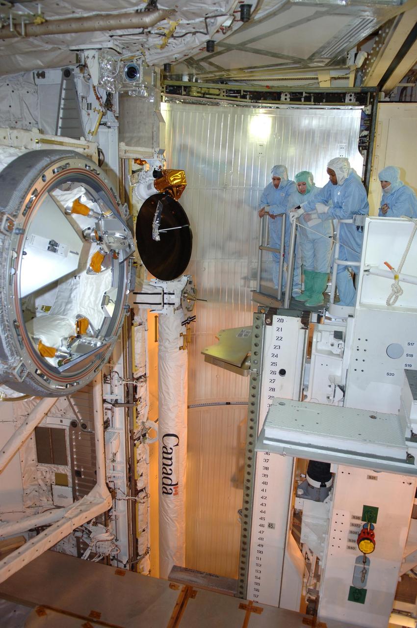 KENNEDY SPACE CENTER, FLA. -- In the payload changeout room on Launch Pad 39B, STS-116 crew members look over the mission payload with payload managers one more time before launch. At left is Pilot William Oefelein.  Second from right is Mission Specialist Robert Curbeam.  The crew is at KSC to take part in Terminal Countdown Demonstration Test activities, which include emergency egress training, a simulated launch countdown and payload familiarization. The TCDT is part of prelaunch preparations for the mission that is scheduled to lift off in a window opening no earlier than Dec. 7.   The STS-116 mission is No. 20 to the International Space Station and construction flight 12A.1.  The mission payload is the SPACEHAB module, the P5 integrated truss structure and other key components.  Photo credit: NASA/Kim Shiflett