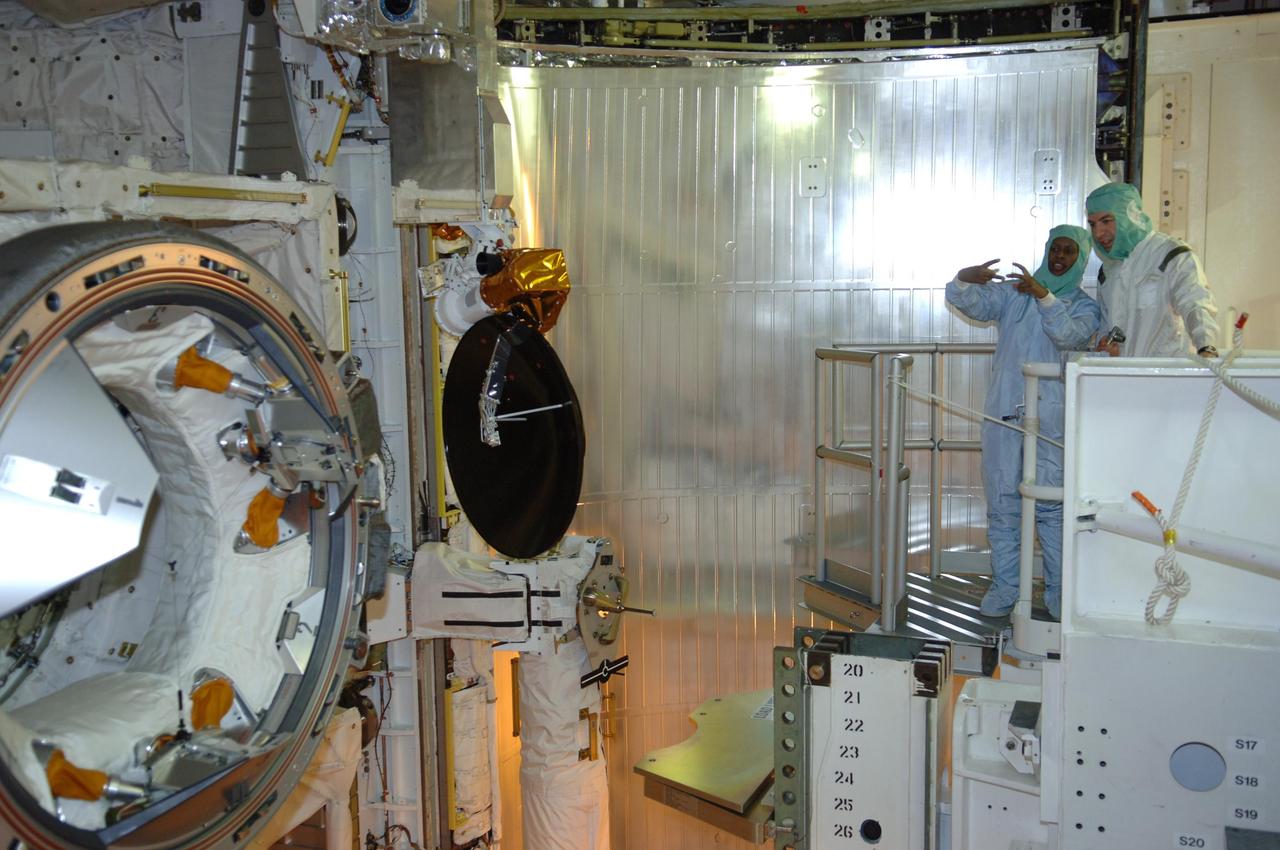 KENNEDY SPACE CENTER, FLA. -- In the payload changeout room on Launch Pad 39B, STS-116 crew members look over the mission payload one more time before launch. Mission Specialist Joan Higginbotham is at left.  The crew is at KSC to take part in Terminal Countdown Demonstration Test activities, which include emergency egress training, a simulated launch countdown and payload familiarization. The TCDT is part of prelaunch preparations for the mission that is scheduled to lift off in a window opening no earlier than Dec. 7.   The STS-116 mission is No. 20 to the International Space Station and construction flight 12A.1.  The mission payload is the SPACEHAB module, the P5 integrated truss structure and other key components.  Photo credit: NASA/Kim Shiflett