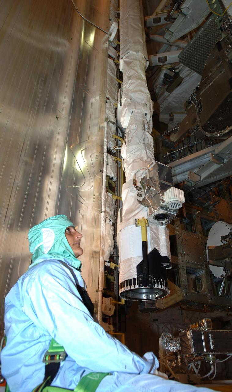 KENNEDY SPACE CENTER, FLA. -- In the payload changeout room on Launch Pad 39B, Expedition 14 Flight Engineer Sunita Williams looks over the STS-116 mission payload one more time before launch. Williams will be traveling aboard Discovery with the STS-116 crew and staying on the International Space Station.  The crew is at KSC to take part in Terminal Countdown Demonstration Test activities, which include emergency egress training, a simulated launch countdown and payload familiarization. The TCDT is part of prelaunch preparations for the mission that is scheduled to lift off in a window opening no earlier than Dec. 7.   The STS-116 mission is No. 20 to the International Space Station and construction flight 12A.1.  The mission payload is the SPACEHAB module, the P5 integrated truss structure and other key components.  Photo credit: NASA/Kim Shiflett