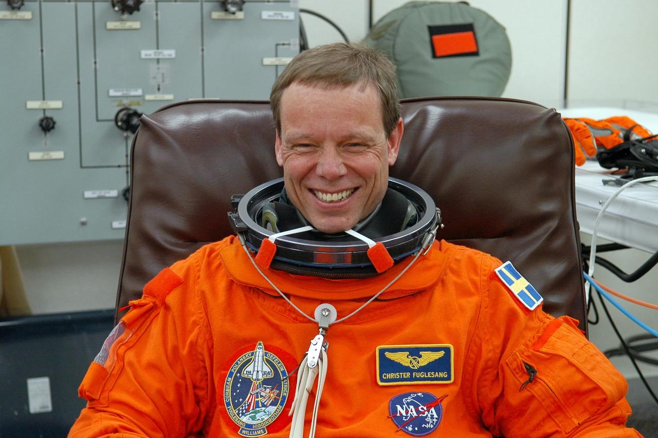 KENNEDY SPACE CENTER, FLA. --  The STS-116 mission crew practices for launch with a simulation of activities, from crew breakfast and suit-up to countdown in the orbiter.  In this photo Mission Specialist Christer Fuglesang, who represents the European Space Agency, grins in anticipation of the launch countdown.  When he is completely suited he will head to Launch Pad 39B.  The STS-116 mission is No. 20 to the International Space Station and construction flight 12A.1.  The mission payload is the SPACEHAB module, the P5 integrated truss structure and other key components. Launch is scheduled for no earlier than Dec. 7. Photo credit: NASA/Kim Shiflett