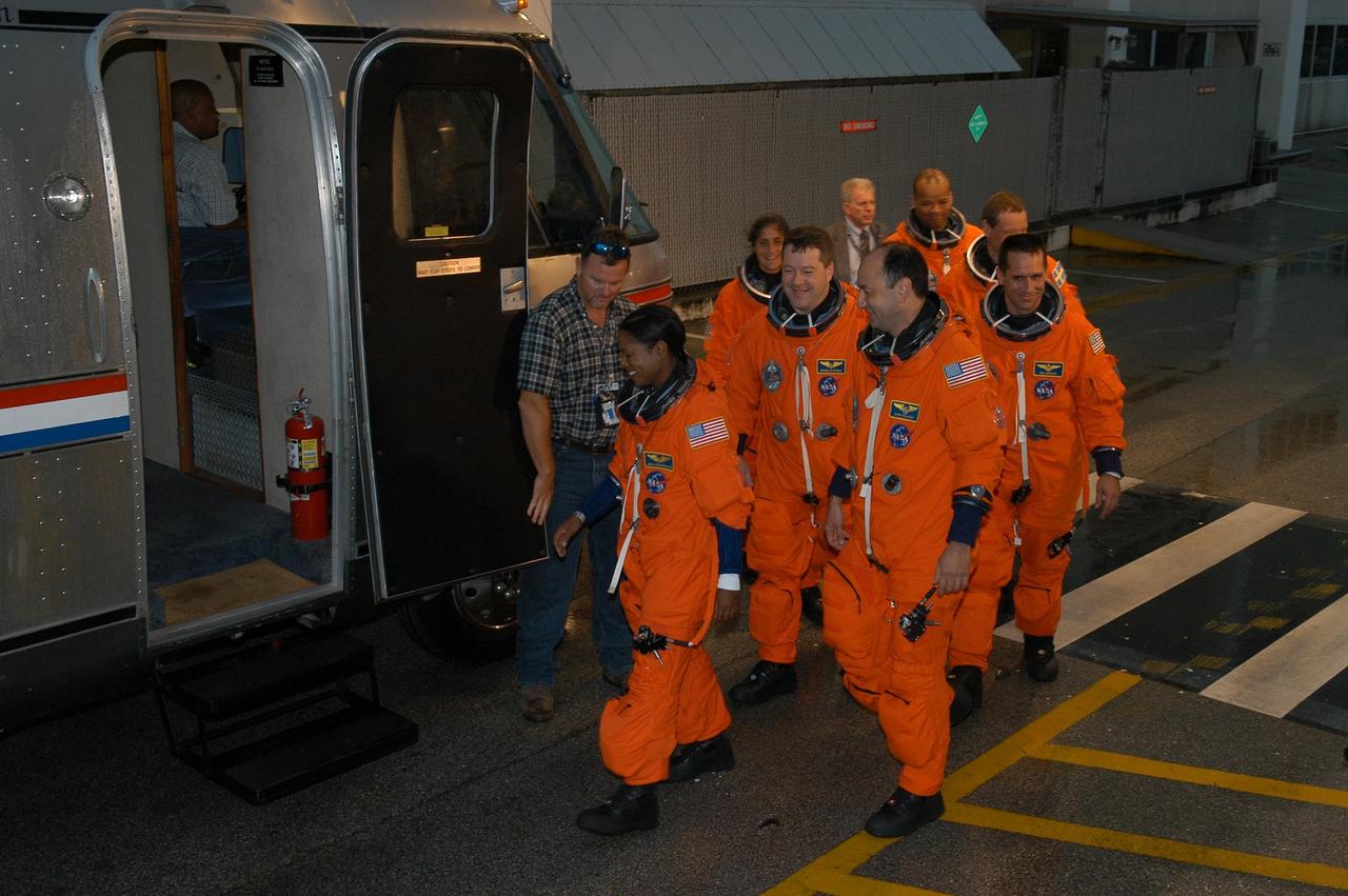 KENNEDY SPACE CENTER, FLA. -- The STS-116 crew eagerly walks to the Astrovan that will take them to Launch Pad 39B and the simulated countdown.  The crew is practicing for launch with a simulation of activities, from crew breakfast and suit-up to countdown in the orbiter.  From left are Mission Specialists Joan Higginbotham, Sunita Williams and Nicholas Patrick; Commander Mark Polansky; Mission Specialists Robert Curbeam and Christer Fuglesang; and Pilot William Oefelein.  The STS-116 mission is No. 20 to the International Space Station and construction flight 12A.1.  The mission payload is the SPACEHAB module, the P5 integrated truss structure and other key components. Launch is scheduled for no earlier than Dec. 7. Photo credit: NASA/Kim Shiflett