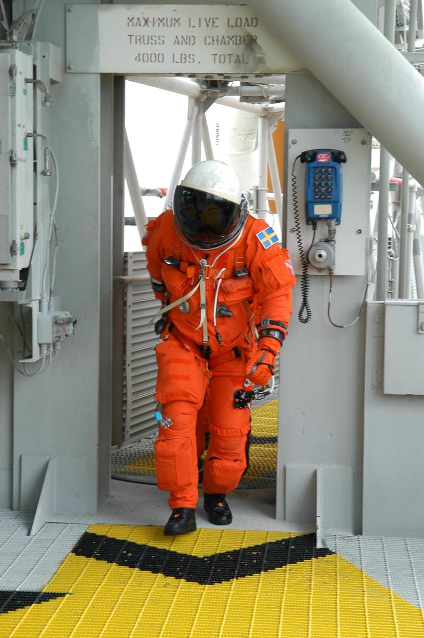 KENNEDY SPACE CENTER, FLA. --  On the 195-foot level of the fixed service structure on Launch Pad 39B, STS-116 Mission Specialist Christer Fuglesang heads for the slidewire baskets.  He and other crew members are practicing the emergency egress procedure to get off the pad, part of the prelaunch preparations known as terminal countdown demonstration test.  The TCDT includes a simulated launch countdown and payload familiarization. The STS-116 mission is No. 20 to the International Space Station and construction flight 12A.1.  The mission payload is the SPACEHAB module, the P5 integrated truss structure and other key components. Launch is scheduled for no earlier than Dec. 7. Photo credit: NASA/Kim Shiflett