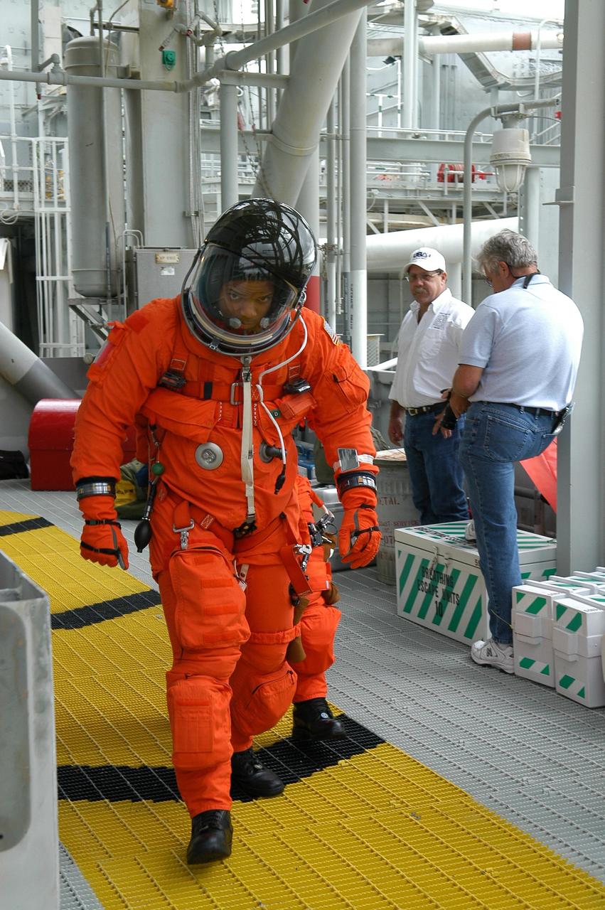 KENNEDY SPACE CENTER, FLA. --  On the 195-foot level of the fixed service structure on Launch Pad 39B, STS-116 Mission Specialist Robert Curbeam heads for the slidewire baskets. He and other crew members are practicing the emergency egress procedure to get off the pad, part of the prelaunch preparations known as terminal countdown demonstration test. The TCDT includes a simulated launch countdown and payload familiarization. The STS-116 mission is No. 20 to the International Space Station and construction flight 12A.1.  The mission payload is the SPACEHAB module, the P5 integrated truss structure and other key components. Launch is scheduled for no earlier than Dec. 7. Photo credit: NASA/Kim Shiflett