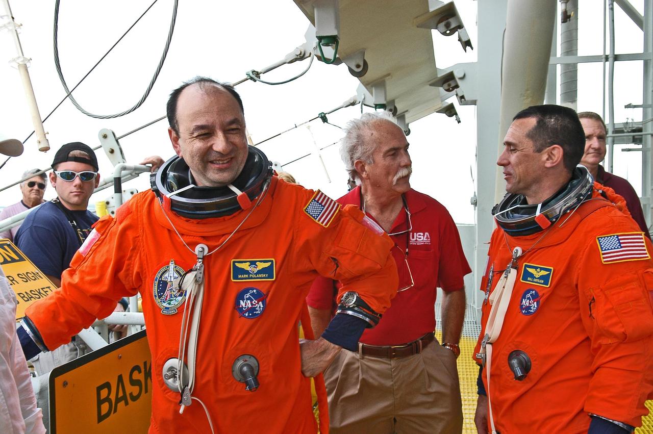 KENNEDY SPACE CENTER, FLA. -- On the 195-foot level of the fixed service structure on Launch Pad 39B, STS-116 crew members gather after completing the emergency egress procedure. Seen here are Commander Mark Polansky (left) and Pilot William Oefelein (right). They and other crew members are practicing the emergency egress system to get off the pad, part of the prelaunch preparations known as terminal countdown demonstration test. The TCDT includes a simulated launch countdown and payload familiarization. The STS-116 mission is No. 20 to the International Space Station and construction flight 12A.1. The mission payload is the SPACEHAB module, the P5 integrated truss structure and other key components. Launch is scheduled for no earlier than Dec. 7. Photo credit: NASA/Kim Shiflett