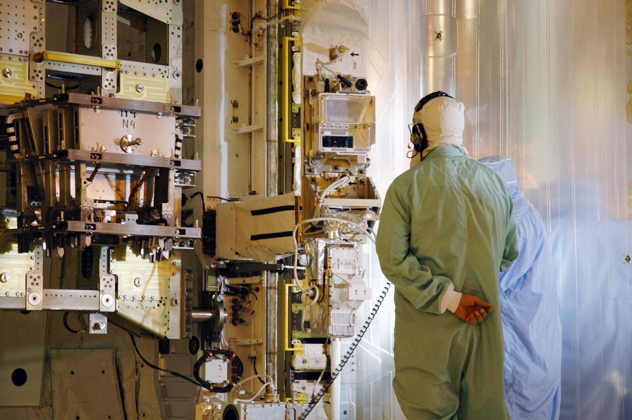 KENNEDY SPACE CENTER, FLA. -- On Launch Pad 39B, workers inside the payload changeout room monitor the closing of the payload bay doors on Space Shuttle Discovery.   The payload includes the SPACEHAB module, the P5 integrated truss structure and other key components. Launch of Space Shuttle Discovery on mission STS-116 is scheduled no earlier than Dec. 7.  Photo credit: NASA/Dimitri Gerondidakis