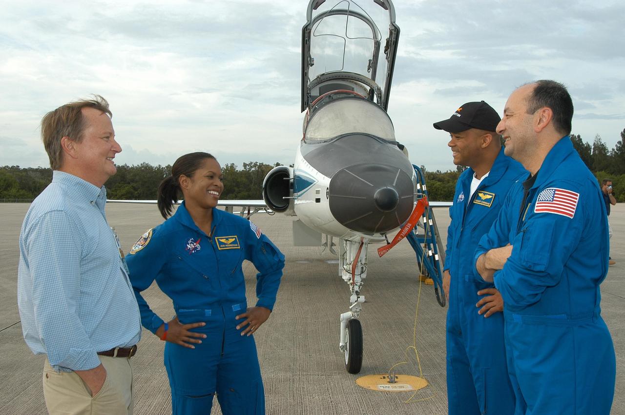 KENNEDY SPACE CENTER, FLA. --  At the Shuttle Landing Facility, Launch Director Mike Leinbach welcomes (from left) STS-116 Mission Specialists Joan Higginbotham, Robert Curbeam and Commander Mark Polansky upon their arrival at KSC aboard T-38 jet aircraft for the launch of Space Shuttle Discovery on Dec. 7. On the mission, the crew will deliver truss segment, P5, to the International Space Station and begin the intricate process of reconfiguring and redistributing the power generated by two pairs of U.S. solar arrays.  The P5 will be mated to the P4 truss that was delivered and attached during the STS-115 mission in September.  Photo credit: NASA/Kim Shiflett