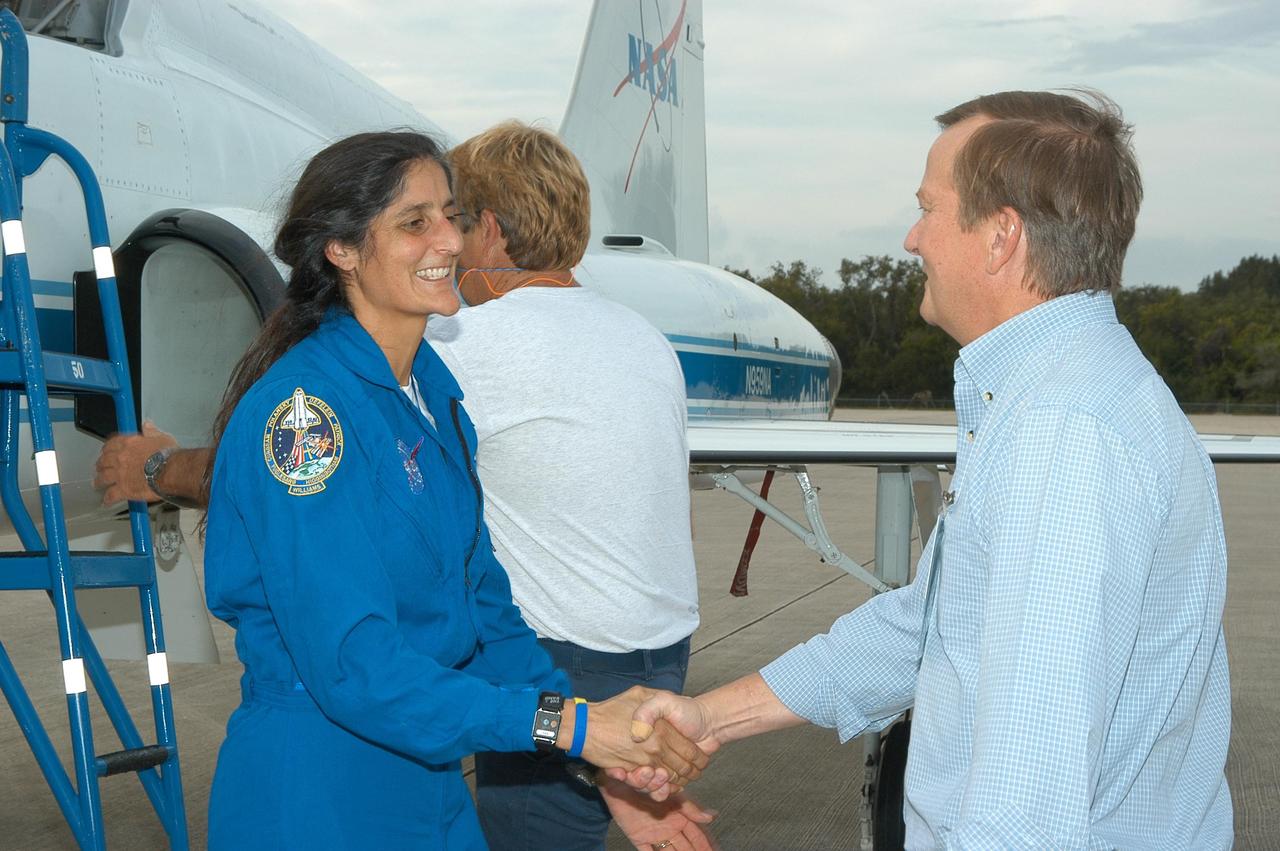 KENNEDY SPACE CENTER, FLA. -- At the Shuttle Landing Facility, Launch Director Mike Leinbach (right) welcomes STS-116 Mission Specialist Sunita Williams upon her arrival at KSC aboard a T-38 jet aircraft for the launch of Space Shuttle Discovery on Dec. 7. Williams will join Expedition 14 in progress aboard the International Space Station as a flight engineer. On the mission, the STS-116 crew will deliver truss segment, P5, to the International Space Station and begin the intricate process of reconfiguring and redistributing the power generated by two pairs of U.S. solar arrays. The P5 will be mated to the P4 truss that was delivered and attached during the STS-115 mission in September. Photo credit: NASA/Kim Shiflett