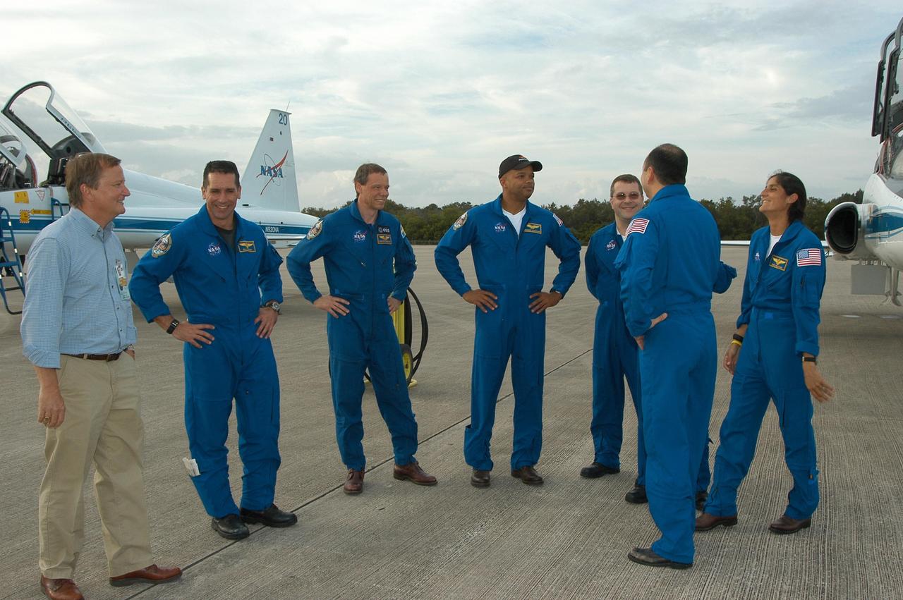 KENNEDY SPACE CENTER, FLA. --  At the Shuttle Landing Facility, Launch Director Mike Leinbach welcomes members of the STS-116 crew upon their arrival at KSC aboard T-38 jet aircraft for the launch of Space Shuttle Discovery on Dec. 7. From left are Leinbach, Pilot William Oefelein, Mission Specialist Christer Fuglesang representing the European Space Agency, Mission Specialists Robert Curbeam and Nicholas Patrick, Commander Mark Polansky (back to camera) and Mission Specialist Sunita Williams joining Expedition 14 in progress on the International Space Station.  On the mission, the STS-116 crew will deliver truss segment, P5, to the International Space Station and begin the intricate process of reconfiguring and redistributing the power generated by two pairs of U.S. solar arrays.  The P5 will be mated to the P4 truss that was delivered and attached during the STS-115 mission in September.  Photo credit: NASA/Kim Shiflett