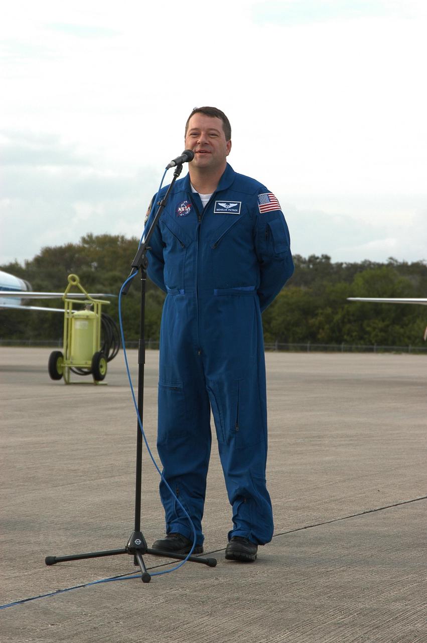 KENNEDY SPACE CENTER, FLA. -- At the Shuttle Landing Facility, STS-116 Mission Specialist Nicholas Patrick makes some remarks to media representatives following his arrival at KSC aboard a T-38 jet aircraft for the launch of Space Shuttle Discovery on Dec. 7. On the mission, the STS-116 crew will deliver truss segment, P5, to the International Space Station and begin the intricate process of reconfiguring and redistributing the power generated by two pairs of U.S. solar arrays. The P5 will be mated to the P4 truss that was delivered and attached during the STS-115 mission in September. Photo credit: NASA/Kim Shiflett
