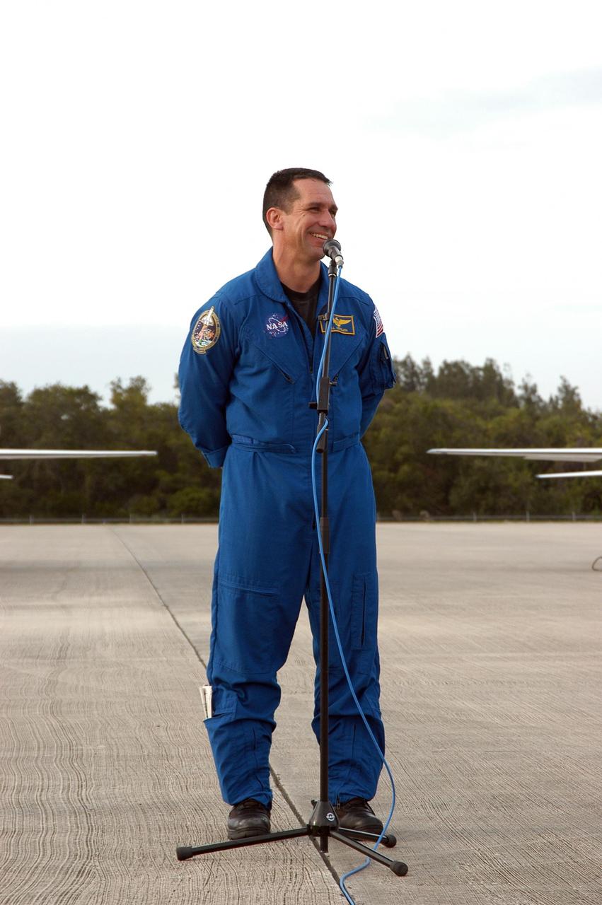 KENNEDY SPACE CENTER, FLA. -- At the Shuttle Landing Facility, STS-116 Pilot William Oefelein addresses media representatives on hand for his arrival at KSC aboard a T-38 jet aircraft for the launch of Space Shuttle Discovery on Dec. 7. On the mission, the STS-116 crew will deliver truss segment, P5, to the International Space Station and begin the intricate process of reconfiguring and redistributing the power generated by two pairs of U.S. solar arrays. The P5 will be mated to the P4 truss that was delivered and attached during the STS-115 mission in September. Photo credit: NASA/Kim Shiflett