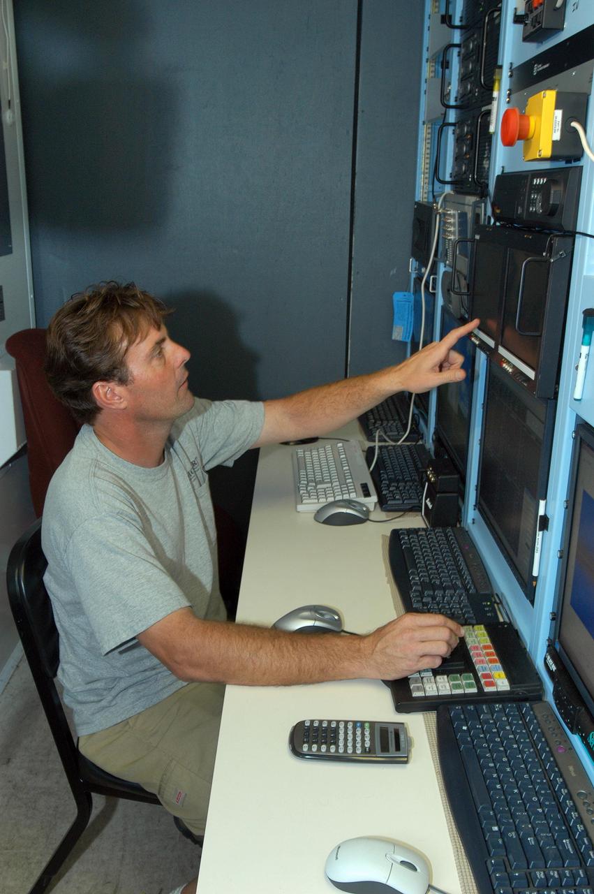 KENNEDY SPACE CENTER, FLA. --  Radar operator Scott Peabody tests the X-band radar array installed on the solid rocket booster retrieval ship Liberty before launch of Space Shuttle Discovery.  It is one of  two Weibel Continuous Pulse Doppler X-band radars located on each of the two SRB retrieval ships.  This one will be located downrange of the launch site. It is one of  two Weibel Continuous Pulse Doppler X-band radars located on each of the two SRB retrieval ships.  This one will be located downrange of the launch site.  Working with the land-based C-band radar, the X-band radars provide velocity and differential shuttle/debris motion information during launch.  The radar data will be sent from the ships via satellite link and analyzed at the C-band radar site located on north Kennedy Space Center.  Photo credit: NASA/George Shelton
