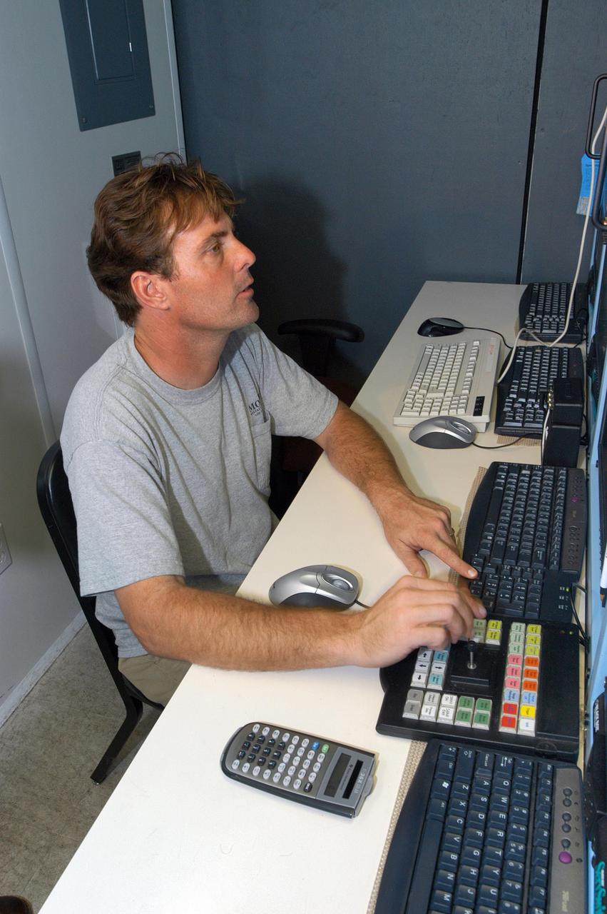 KENNEDY SPACE CENTER, FLA. --  Radar operator Scott Peabody tests the X-band radar array installed on the solid rocket booster retrieval ship Liberty before launch of Space Shuttle Discovery.  It is one of  two Weibel Continuous Pulse Doppler X-band radars located on each of the two SRB retrieval ships.  This one will be located downrange of the launch site. It is one of  two Weibel Continuous Pulse Doppler X-band radars located on each of the two SRB retrieval ships.  This one will be located downrange of the launch site.  Working with the land-based C-band radar, the X-band radars provide velocity and differential shuttle/debris motion information during launch.  The radar data will be sent from the ships via satellite link and analyzed at the C-band radar site located on north Kennedy Space Center.  Photo credit: NASA/George Shelton