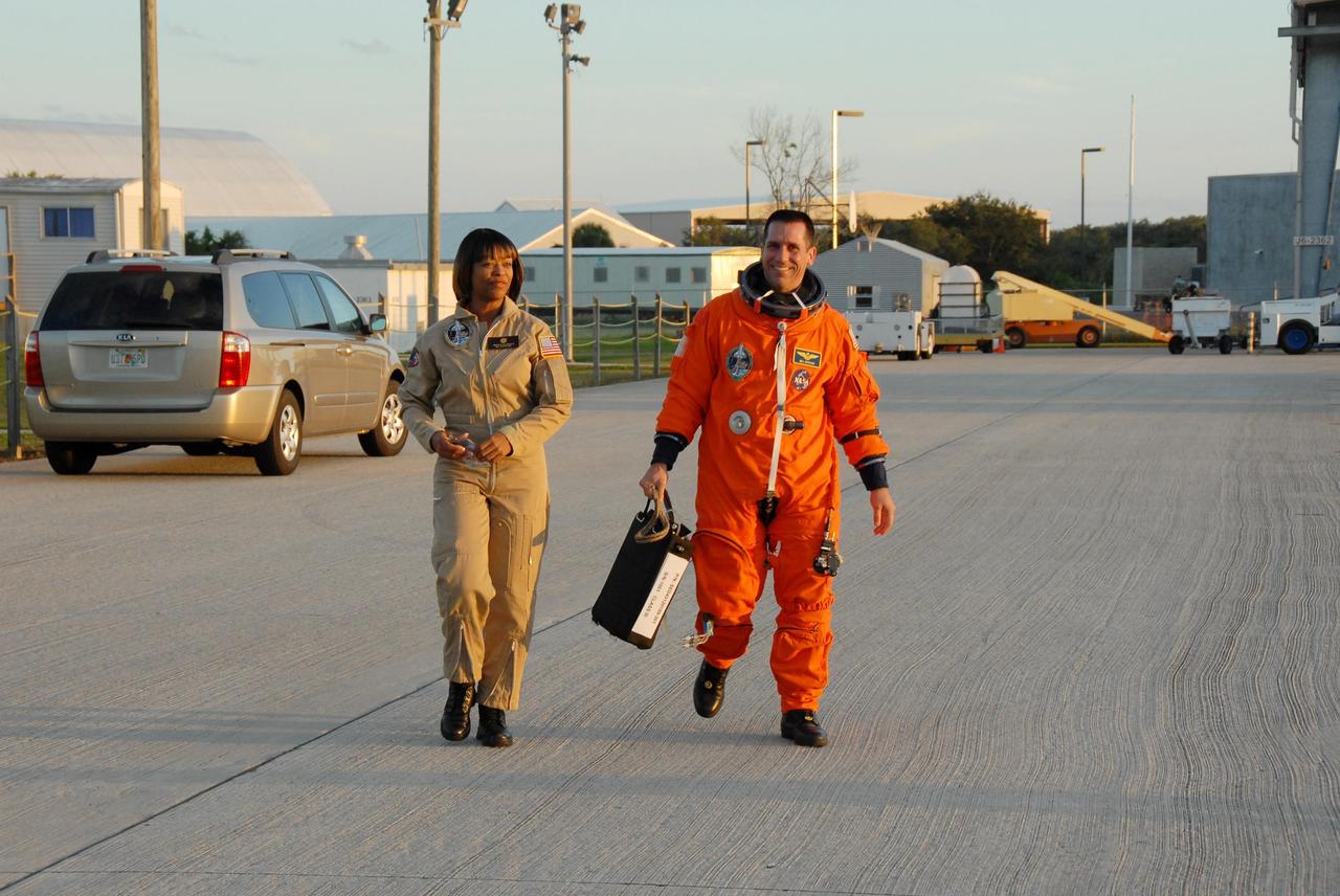 KENNEDY SPACE CENTER, FLA. --   STS-116 Pilot William Oefelein (right) is suited and ready to begin practice flights on the shuttle training aircraft (STA)  two days before launch. The STA is a Grumman American Aviation-built Gulf Stream II jet that was modified to simulate an orbiter's cockpit, motion and visual cues, and handling qualities. In flight, the STA duplicates the orbiter's atmospheric descent trajectory from approximately 35,000 feet altitude to landing on a runway. Because the orbiter is unpowered during re-entry and landing, its high-speed glide must be perfectly executed the first time. Launch of Space Shuttle Discovery on mission STS-116 is scheduled for 9:35 p.m. Dec. 7. On the mission, the STS-116 crew will deliver truss segment, P5, to the International Space Station and begin the intricate process of reconfiguring and redistributing the power generated by two pairs of U.S. solar arrays. The P5 will be mated to the P4 truss that was delivered and attached during the STS-115 mission in September. Photo credit: NASA/Kim Shiflett