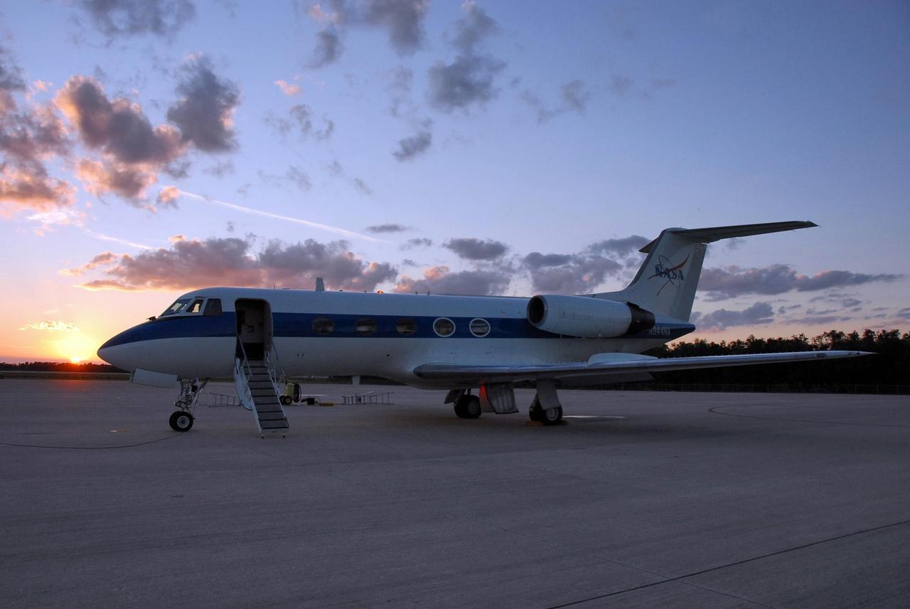 KENNEDY SPACE CENTER, FLA. --  Just at sunset, the shuttle training aircraft (STA), with STS-116 Pilot William Oefelein in the pilot's seat, waits on the Shuttle Landing Facility for the right moment to take off for orbiter landing practice.  The STA is a Grumman American Aviation-built Gulf Stream II jet that was modified to simulate an orbiter's cockpit, motion and visual cues, and handling qualities. In flight, the STA duplicates the orbiter's atmospheric descent trajectory from approximately 35,000 feet altitude to landing on a runway. Because the orbiter is unpowered during re-entry and landing, its high-speed glide must be perfectly executed the first time. Launch of Space Shuttle Discovery on mission STS-116 is scheduled for 9:35 p.m. Dec. 7. On the mission, the STS-116 crew will deliver truss segment, P5, to the International Space Station and begin the intricate process of reconfiguring and redistributing the power generated by two pairs of U.S. solar arrays. The P5 will be mated to the P4 truss that was delivered and attached during the STS-115 mission in September. Photo credit: NASA/Kim Shiflett