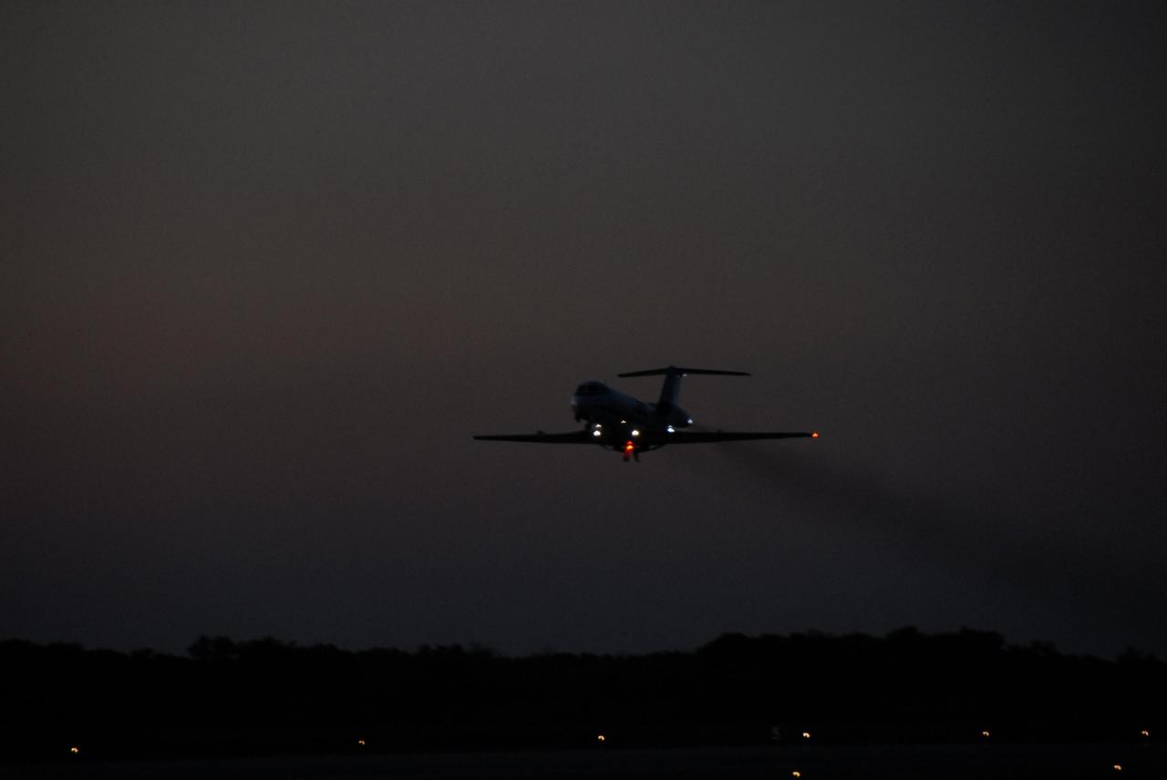 KENNEDY SPACE CENTER, FLA. --   Into the night flies the shuttle training aircraft (STA) with STS-116 Pilot William Oefelein in the pilot's seat, ready to start orbiter landing practice.  The STA is a Grumman American Aviation-built Gulf Stream II jet that was modified to simulate an orbiter's cockpit, motion and visual cues, and handling qualities. In flight, the STA duplicates the orbiter's atmospheric descent trajectory from approximately 35,000 feet altitude to landing on a runway. Because the orbiter is unpowered during re-entry and landing, its high-speed glide must be perfectly executed the first time. Launch of Space Shuttle Discovery on mission STS-116 is scheduled for 9:35 p.m. Dec. 7. On the mission, the STS-116 crew will deliver truss segment, P5, to the International Space Station and begin the intricate process of reconfiguring and redistributing the power generated by two pairs of U.S. solar arrays. The P5 will be mated to the P4 truss that was delivered and attached during the STS-115 mission in September. Photo credit: NASA/Kim Shiflett