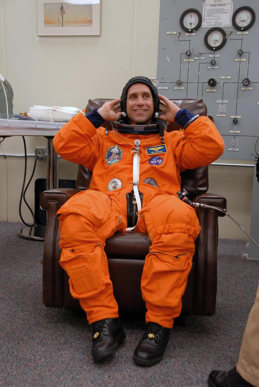 KENNEDY SPACE CENTER, FLA. --   Following orbiter landing practice in the shuttle training aircraft (STA), STS-116 Pilot William Oefelein gives a final check to his launch suit.  Launch of Space Shuttle Discovery on mission STS-116 is scheduled for 9:35 p.m. Dec. 7. On the mission, the STS-116 crew will deliver truss segment, P5, to the International Space Station and begin the intricate process of reconfiguring and redistributing the power generated by two pairs of U.S. solar arrays. The P5 will be mated to the P4 truss that was delivered and attached during the STS-115 mission in September. Photo credit: NASA/Kim Shiflett