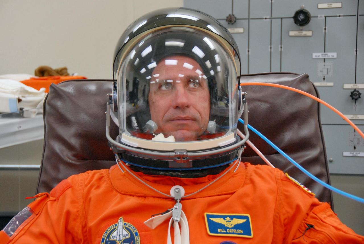 KENNEDY SPACE CENTER, FLA. --    Following orbiter landing practice in the shuttle training aircraft (STA), STS-116 Pilot William Oefelein has completed suit fit-check with his helmet.  Launch of Space Shuttle Discovery on mission STS-116 is scheduled for 9:35 p.m. Dec. 7. On the mission, the STS-116 crew will deliver truss segment, P5, to the International Space Station and begin the intricate process of reconfiguring and redistributing the power generated by two pairs of U.S. solar arrays. The P5 will be mated to the P4 truss that was delivered and attached during the STS-115 mission in September. Photo credit: NASA/Kim Shiflett