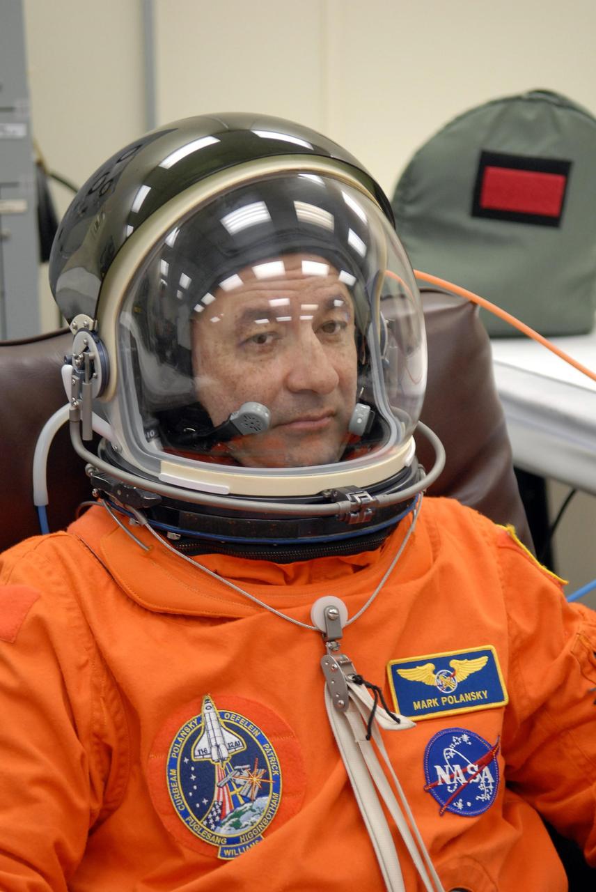 KENNEDY SPACE CENTER, FLA. -- The crew members of mission STS-116 are suiting up for launch at 9:35 p.m. EST from Launch Pad 39B aboard Space Shuttle Discovery.  Pictured here is Commander Mark Polansky, after donning his helmet.  Polansky will be making his second shuttle flight. This is Discovery's 33rd mission and the first night launch since 2003.   The 20th shuttle mission to the International Space Station, STS-116 carries another truss segment, P5. It will serve as a spacer, mated to the P4 truss that was attached in September.  After installing the P5, the crew will reconfigure and redistribute the power generated by two pairs of U.S. solar arrays. Landing is expected Dec. 19 at KSC.   Photo credit: NASA/Kim Shiflett