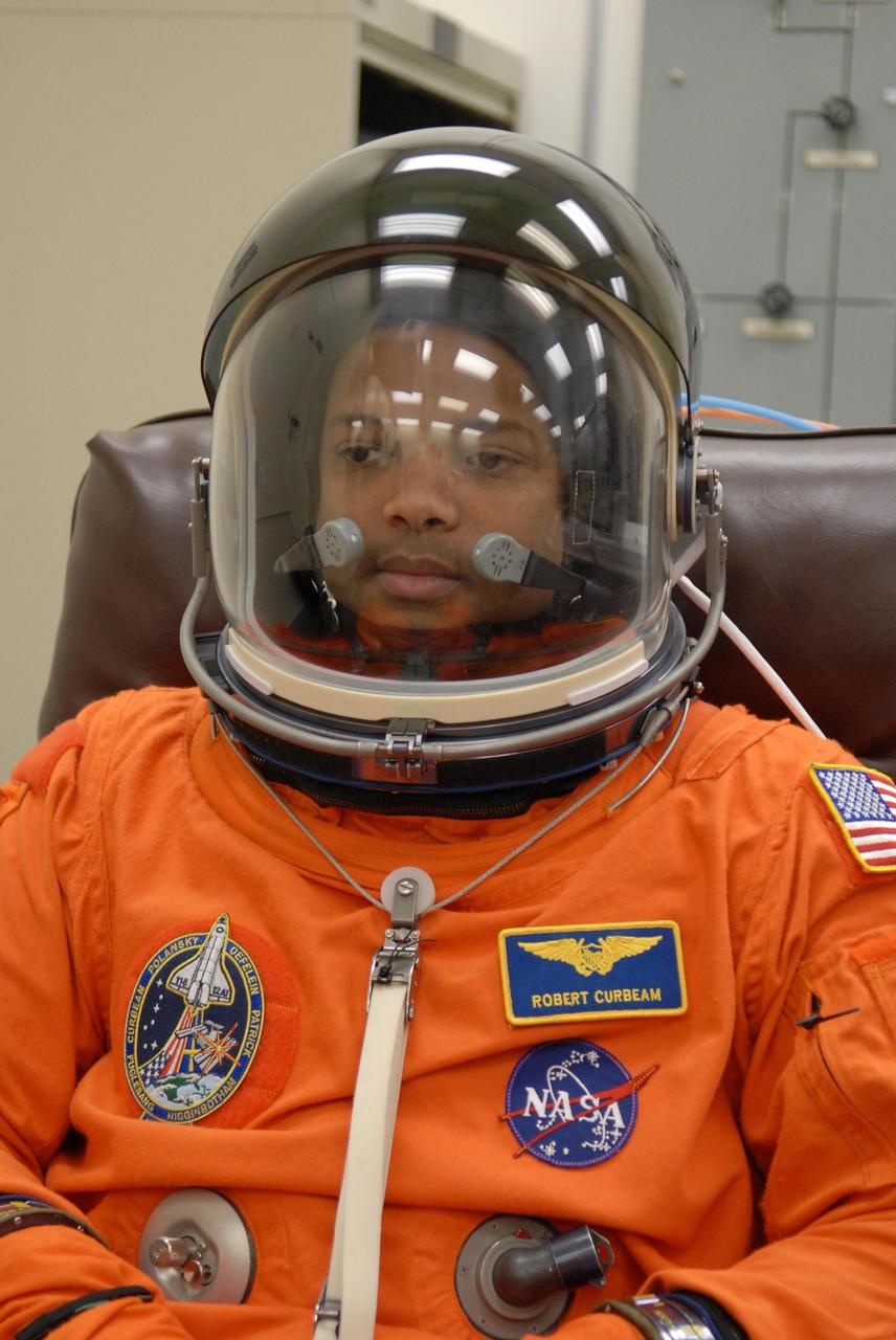 KENNEDY SPACE CENTER, FLA. -- The crew members of mission STS-116 are suiting up for launch at 9:35 p.m. EST from Launch Pad 39B aboard Space Shuttle Discovery.  Pictured here is Mission Specialist Robert Curbeam, after donning his helmet.  Curbeam will be making his third shuttle flight.  This is Discovery's 33rd mission and the first night launch since 2003.   The 20th shuttle mission to the International Space Station, STS-116 carries another truss segment, P5. It will serve as a spacer, mated to the P4 truss that was attached in September.  After installing the P5, the crew will reconfigure and redistribute the power generated by two pairs of U.S. solar arrays. Landing is expected Dec. 19 at KSC.   Photo credit: NASA/Kim Shiflett