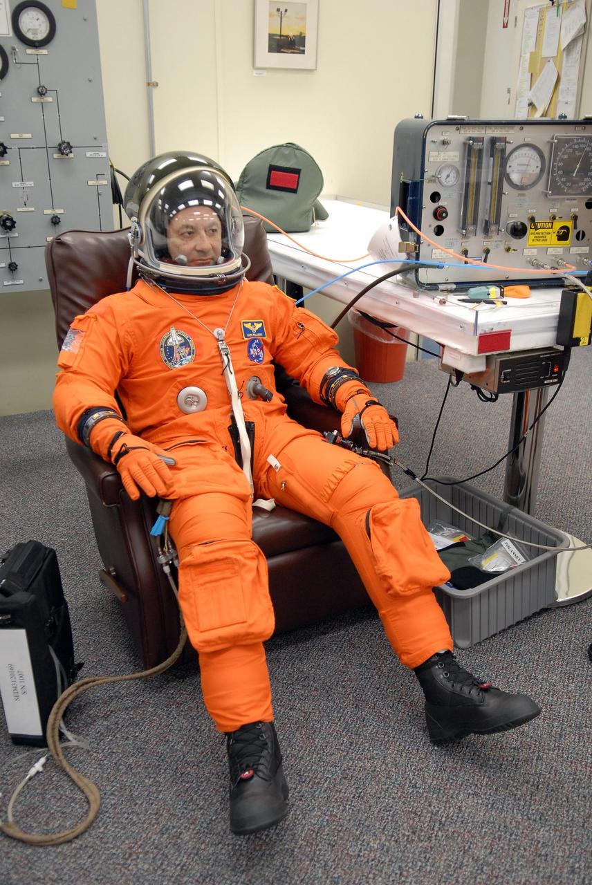 KENNEDY SPACE CENTER, FLA. -- The crew members of mission STS-116 are suiting up for launch at 9:35 p.m. EST from Launch Pad 39B aboard Space Shuttle Discovery. Here, Commander Mark Polansky has completed donning all the elements, from boots to helmet. Polansky will be making his second shuttle flight. This is Discovery's 33rd mission and the first night launch since 2003. The 20th shuttle mission to the International Space Station, STS-116 carries another truss segment, P5. It will serve as a spacer, mated to the P4 truss that was attached in September. After installing the P5, the crew will reconfigure and redistribute the power generated by two pairs of U.S. solar arrays. Landing is expected Dec. 19 at KSC. Photo credit: NASA/Kim Shiflett