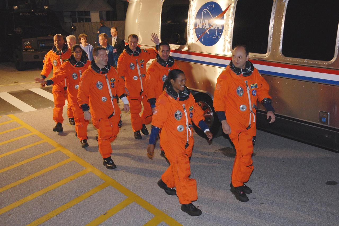 KENNEDY SPACE CENTER, FLA. --  The STS-116 crew walks to the Astrovan for the drive to Launch Pad 39B.  From left are Mission Specialists Robert Curbeam, Sunita Williams, Nicholas Patrick and Christer Fuglesang; Pilot William Oefelein; Mission Specialist Joan Higginbotham; and Commander Mark Polansky. Fuglesang represents the European Space Agency.  Williams will replace Expedition 14 crew member Thomas Reiter, who will return to Earth aboard Discovery in her place. This is Discovery's 33rd mission and the first night launch since 2002.   The 20th shuttle mission to the International Space Station, STS-116 carries another truss segment, P5. It will serve as a spacer, mated to the P4 truss that was attached in September.  After installing the P5, the crew will reconfigure and redistribute the power generated by two pairs of U.S. solar arrays. Landing is expected Dec. 19 at KSC.   Photo credit: NASA/Kim Shiflett