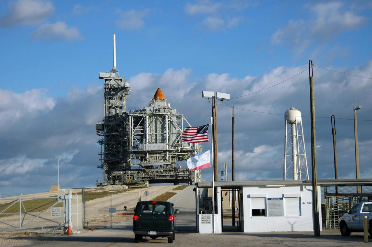 KENNEDY SPACE CENTER, FLA. --   On the morning of the second launch attempt, Space Shuttle Discovery is ready on Launch Pad 39B.  It is still surrounded by the rotating service structure, hiding all but the top of the external tank.  On the left side is the fixed service structure, topped by the 80-foot-tall lightning mast. The first launch attempt of STS-116 Dec. 7 was postponed due a low cloud ceiling over Kennedy Space Center. The next launch attempt was scheduled for Saturday, Dec. 9, at 8:47 p.m. This will be Discovery's 33rd mission and the first night launch since 2002.   The 20th shuttle mission to the International Space Station, STS-116 carries another truss segment, P5. It will serve as a spacer, mated to the P4 truss that was attached in September.  After installing the P5, the crew will reconfigure and redistribute the power generated by two pairs of U.S. solar arrays. Landing is expected Dec. 19 at KSC.  Photo credit: NASA/Ken Thornsley
