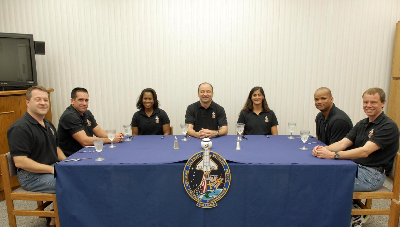 KENNEDY SPACE CENTER, FLA. --    The crew members of mission STS-116 gather around the table for breakfast before suiting up for a second launch attempt aboard Space Shuttle Discovery.  From left are Mission Specialist Nicholas Patrick, Pilot William Oefelein, Mission Specialist Joan Higginbotham, Commander Mark Polansky, and Mission Specialists Sunita Williams, Robert Curbeam and Christer Fuglesang, who represents the European Space Agency.  Williams will replace Expedition 14 crew member Thomas Reiter, who will return to Earth aboard Discovery in her place.   The first launch attempt of STS-116 Dec. 7 was postponed due a low cloud ceiling over Kennedy Space Center. This second launch attempt is scheduled for 8:47 p.m. This is Discovery's 33rd mission and the first night launch since 2002.   The 20th shuttle mission to the International Space Station, STS-116 carries another truss segment, P5. It will serve as a spacer, mated to the P4 truss that was attached in September.  After installing the P5, the crew will reconfigure and redistribute the power generated by two pairs of U.S. solar arrays. Landing is expected Dec. 19 at KSC.   Photo credit: NASA/Kim Shiflett