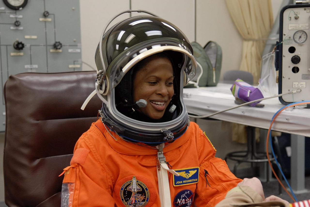 KENNEDY SPACE CENTER, FLA. --   The crew members of mission STS-116 are suiting up for a second launch attempt at 8:47 p.m. EST from Launch Pad 39B aboard Space Shuttle Discovery.  Pictured here, Mission Specialist Joan Higginbotham, who will be making her first shuttle flight, has donned her helmet.  The first launch attempt of STS-116 on Dec. 7 was postponed due a low cloud ceiling over Kennedy Space Center. This is Discovery's 33rd mission and the first night launch since 2002.   The 20th shuttle mission to the International Space Station, STS-116 carries another truss segment, P5. It will serve as a spacer, mated to the P4 truss that was attached in September.  After installing the P5, the crew will reconfigure and redistribute the power generated by two pairs of U.S. solar arrays. Landing is expected Dec. 19 at KSC.   Photo credit: NASA/Kim Shiflett