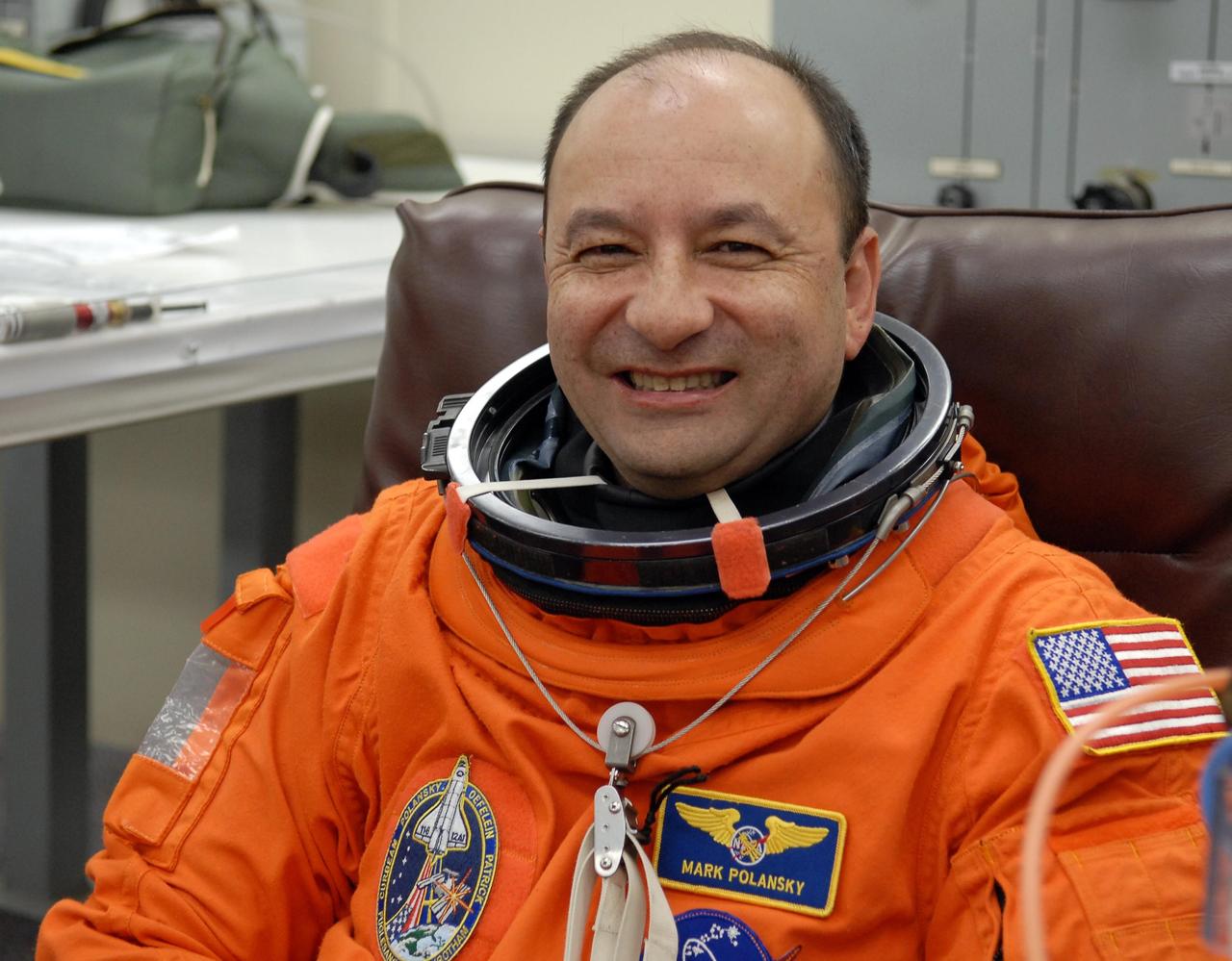 KENNEDY SPACE CENTER, FLA. --   The crew members of mission STS-116 are suiting up for a second launch attempt at 8:47 p.m. EST from Launch Pad 39B aboard Space Shuttle Discovery.   Pictured here is Commander Mark Polansky, who shows his delight in progressing toward another launch attempt. The first launch attempt of STS-116 on Dec. 7 was postponed due a low cloud ceiling over Kennedy Space Center. This is Discovery's 33rd mission and the first night launch since 2002.   The 20th shuttle mission to the International Space Station, STS-116 carries another truss segment, P5. It will serve as a spacer, mated to the P4 truss that was attached in September.  After installing the P5, the crew will reconfigure and redistribute the power generated by two pairs of U.S. solar arrays. Landing is expected Dec. 19 at KSC.   Photo credit: NASA/Kim Shiflett