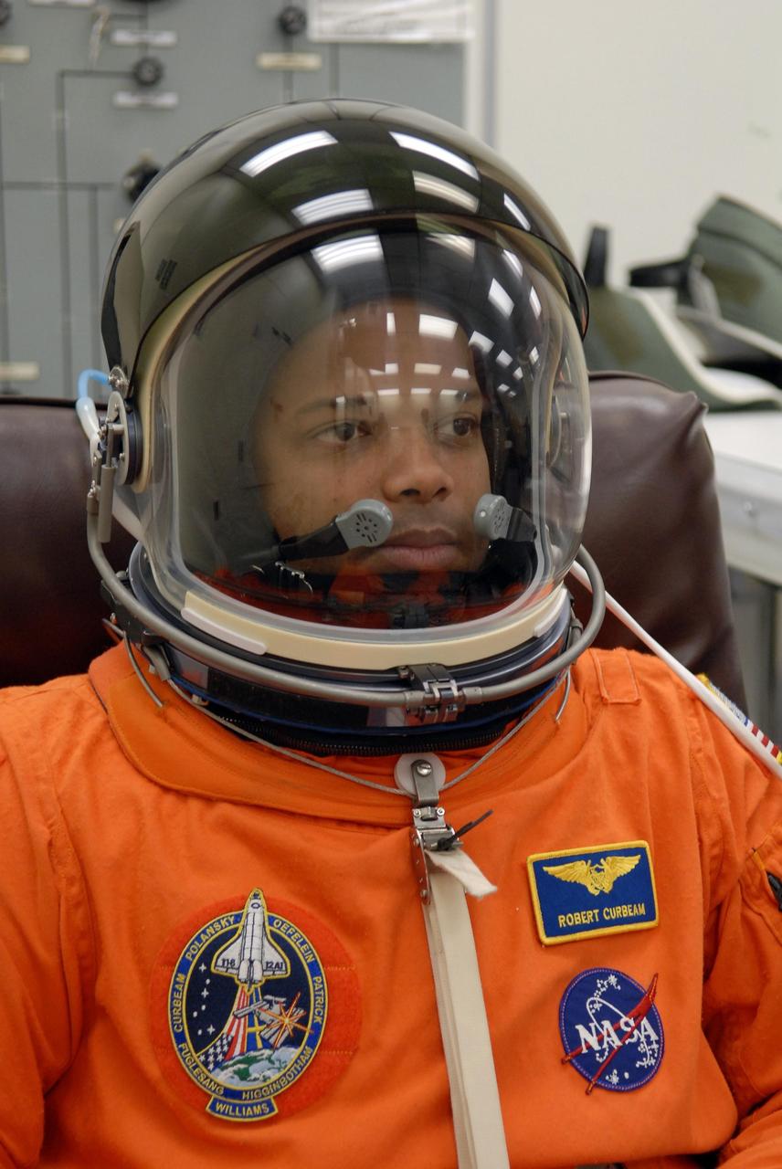 KENNEDY SPACE CENTER, FLA. --   The crew members of mission STS-116 are suiting up for a second launch attempt at 8:47 p.m. EST from Launch Pad 39B aboard Space Shuttle Discovery.   Pictured here is Mission Specialist Robert Curbeam, after donning his helmet.  Curbeam will be making his third shuttle flight. The first launch attempt of STS-116 on Dec. 7 was postponed due a low cloud ceiling over Kennedy Space Center. This is Discovery's 33rd mission and the first night launch since 2002.   The 20th shuttle mission to the International Space Station, STS-116 carries another truss segment, P5. It will serve as a spacer, mated to the P4 truss that was attached in September.  After installing the P5, the crew will reconfigure and redistribute the power generated by two pairs of U.S. solar arrays. Landing is expected Dec. 19 at KSC.   Photo credit: NASA/Kim Shiflett